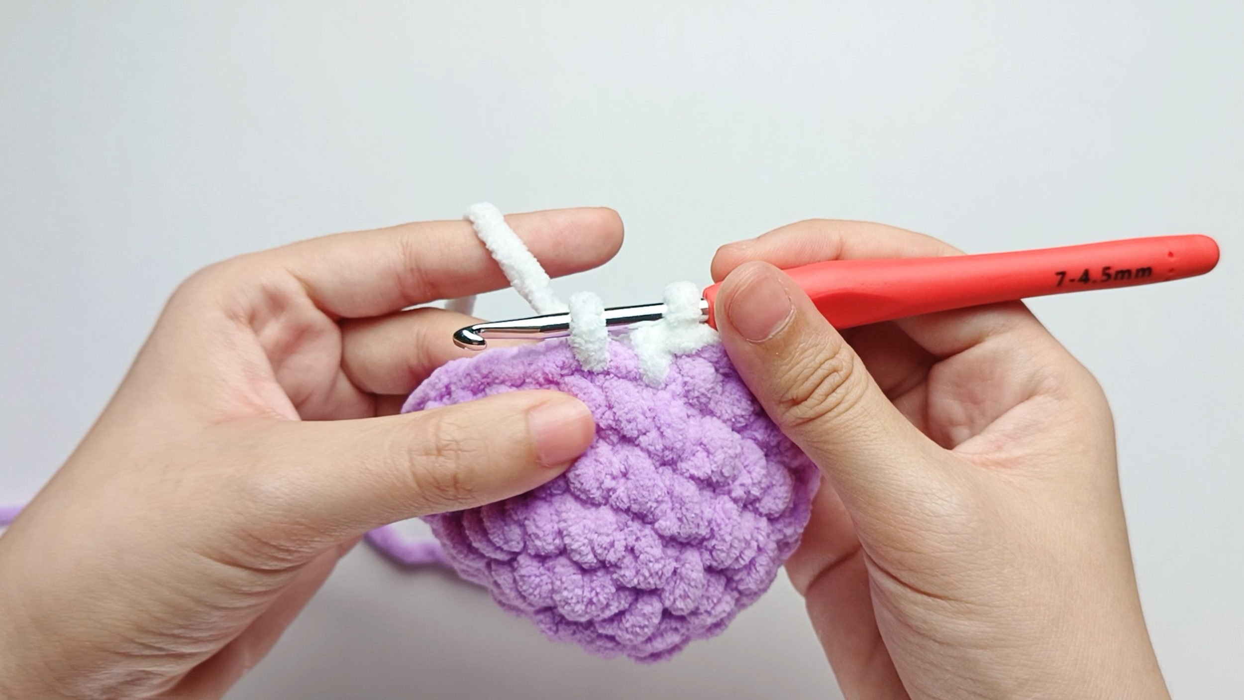 Make 2 white single crochets (sc): Stop just before the final yarn over.