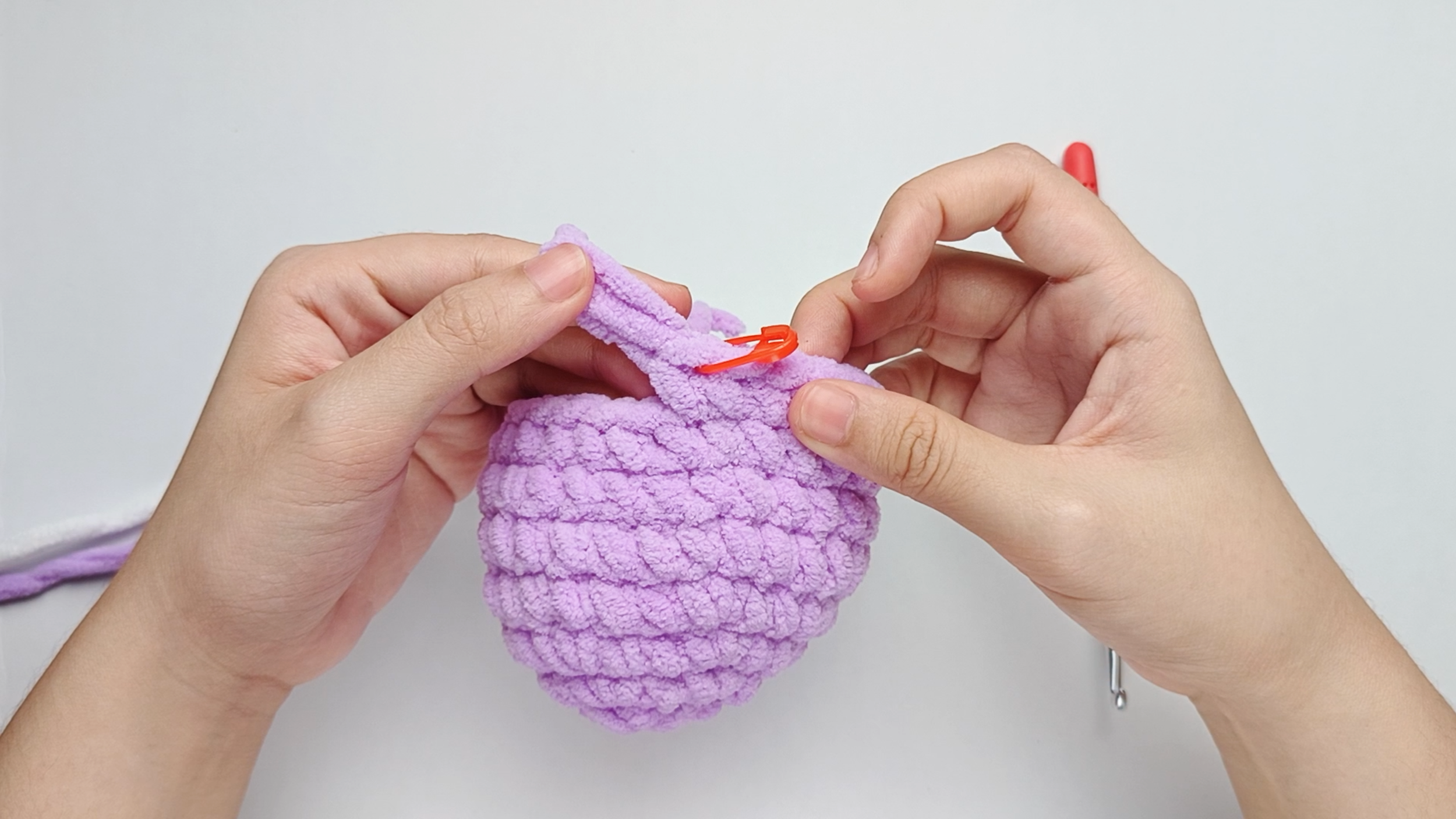 Mark the first stitch: Remove your hook for a moment, and use the stitch marker to mark this first stitch.
