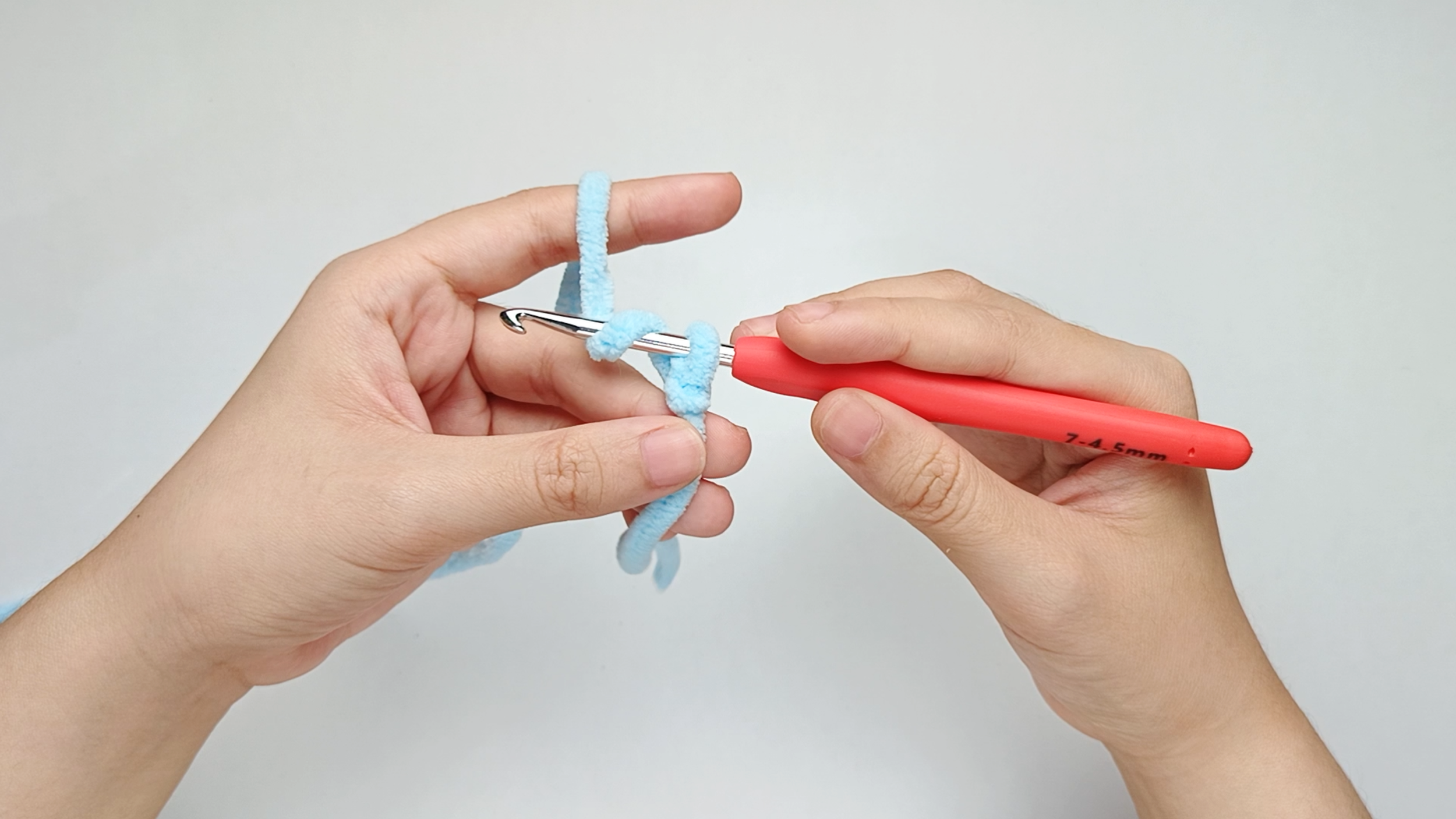 Yarn over: With the hook tip facing you and in front of the working yarn, yarn over.