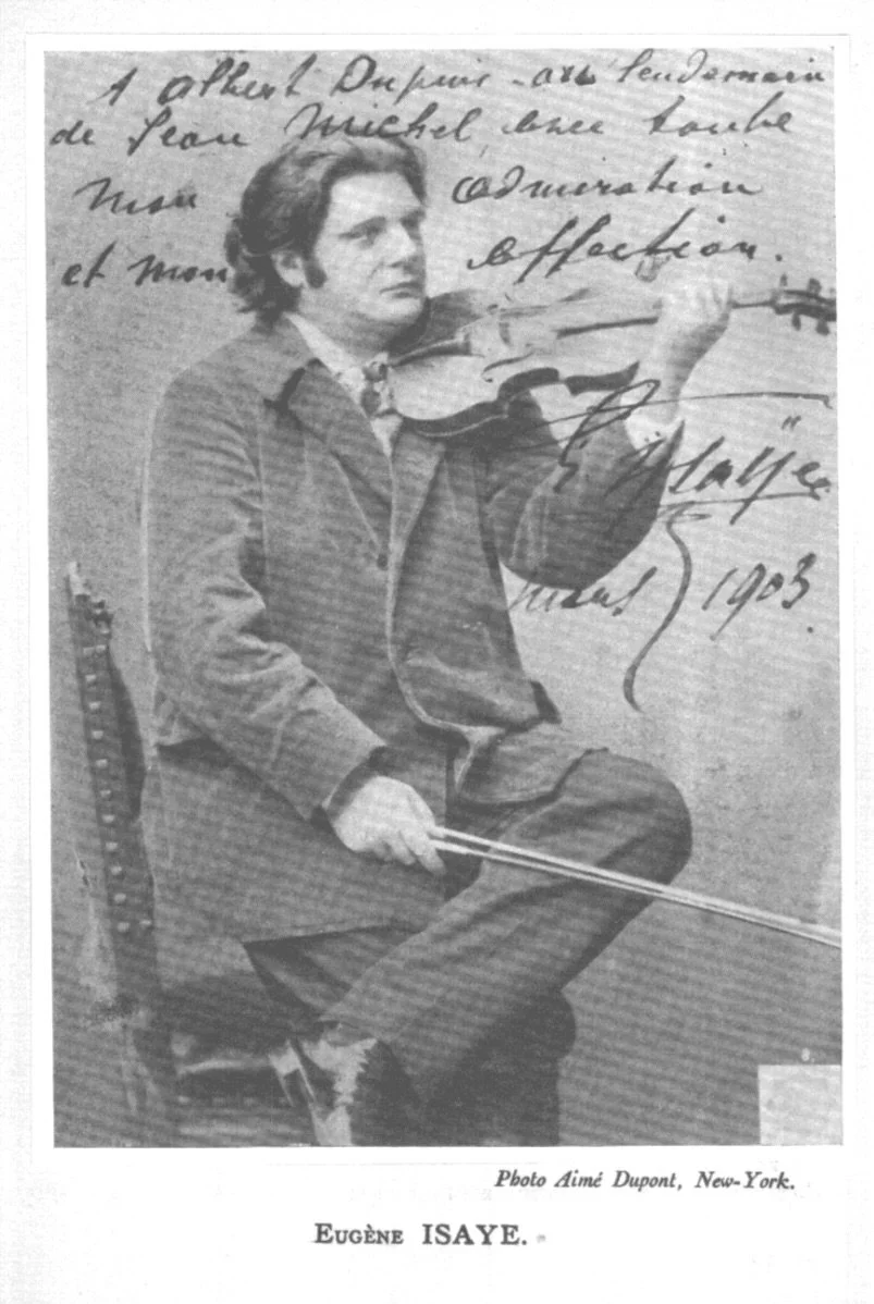 Black-and-white photograph of a man playing the violin, sitting on a chair. The man is wearing a jacket and appears focused. There is handwritten text overlaying the image, and a caption at the bottom reads "Photo Aimé Dupont, New York." The person's name is Eugen Isaye, and the image appears to be from 1903.