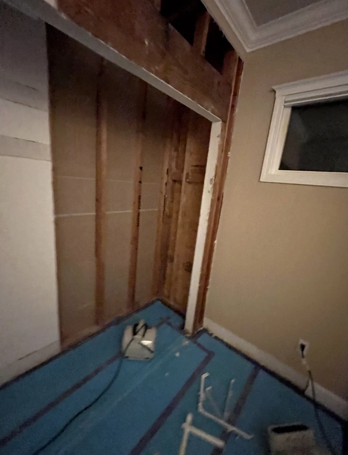 Room under renovation with exposed wooden wall studs, after removing the water damage materials and mold, we thoroughly dry, clean, sanitize, healthy, and fully restored environment.