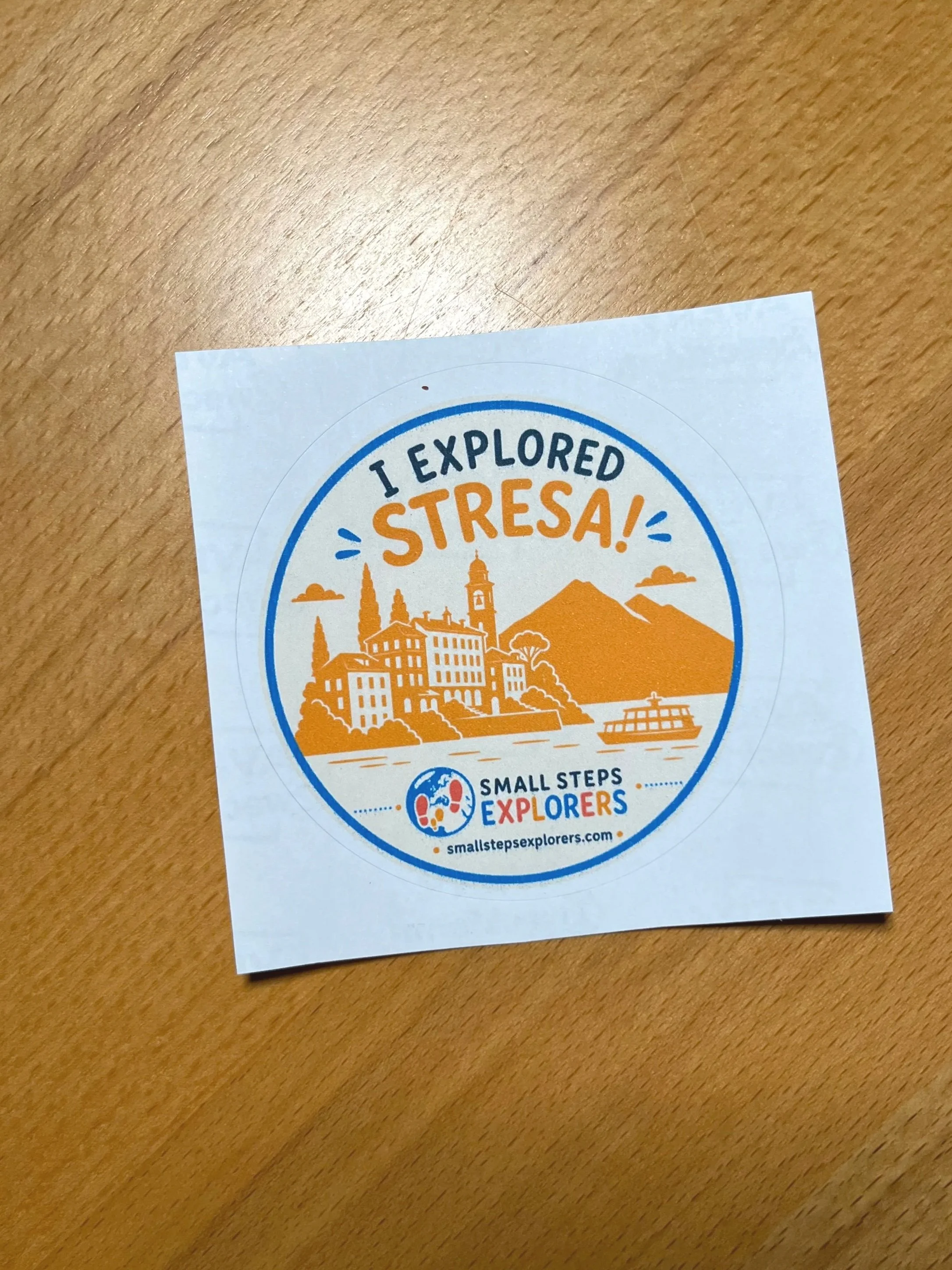 I Explored Stresa explorer passport badge sticker — circular illustrated reward for kids completing the Small Steps Explorers scavenger hunt