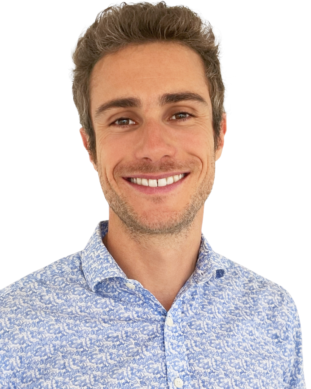 Smiling man with short curly brown hair and light skin, wearing a blue and white patterned button-up shirt against a white background.