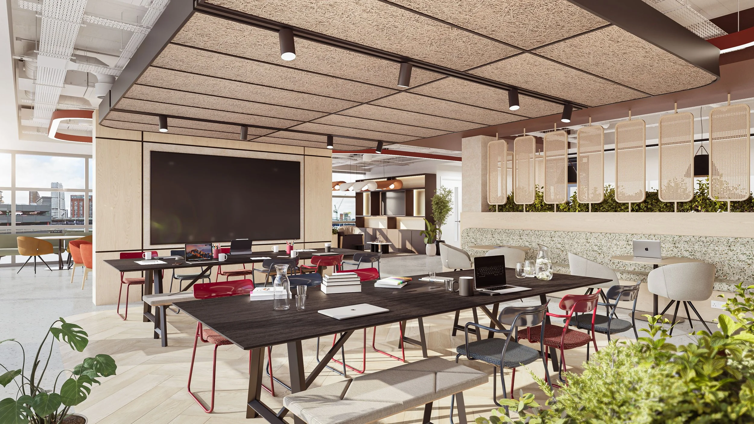 Modern open-plan office with a large wall-mounted screen, meeting tables with laptops, notebooks, and cups, and a mix of colorful chairs. The ceiling has textured panels and spotlights, and there are large windows with city view, greenery, and decorative screens dividing the space.