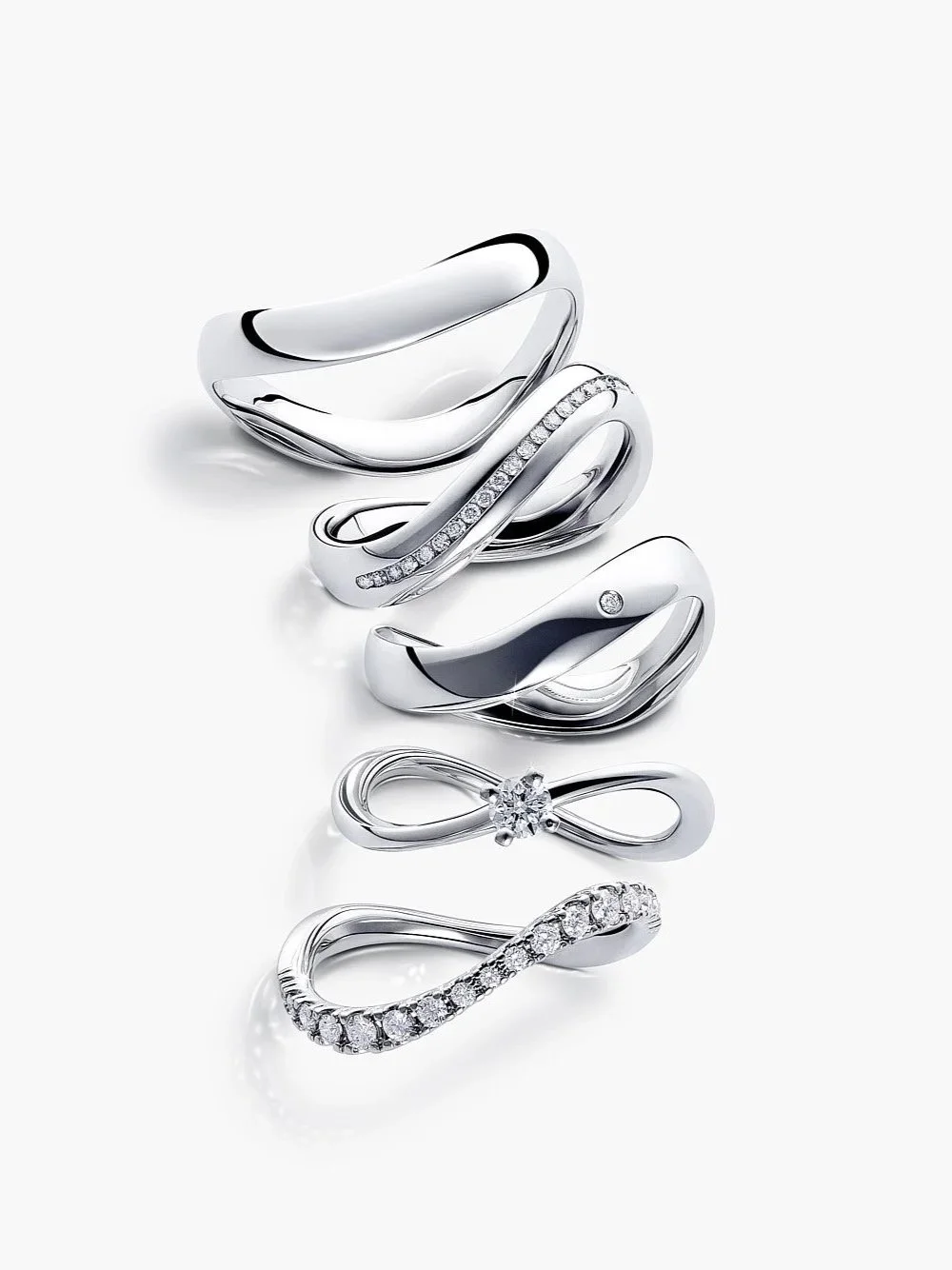 Collection of ZC silver rings with various designs, including some with diamonds and crystalline embellishments, displayed on a white background.
