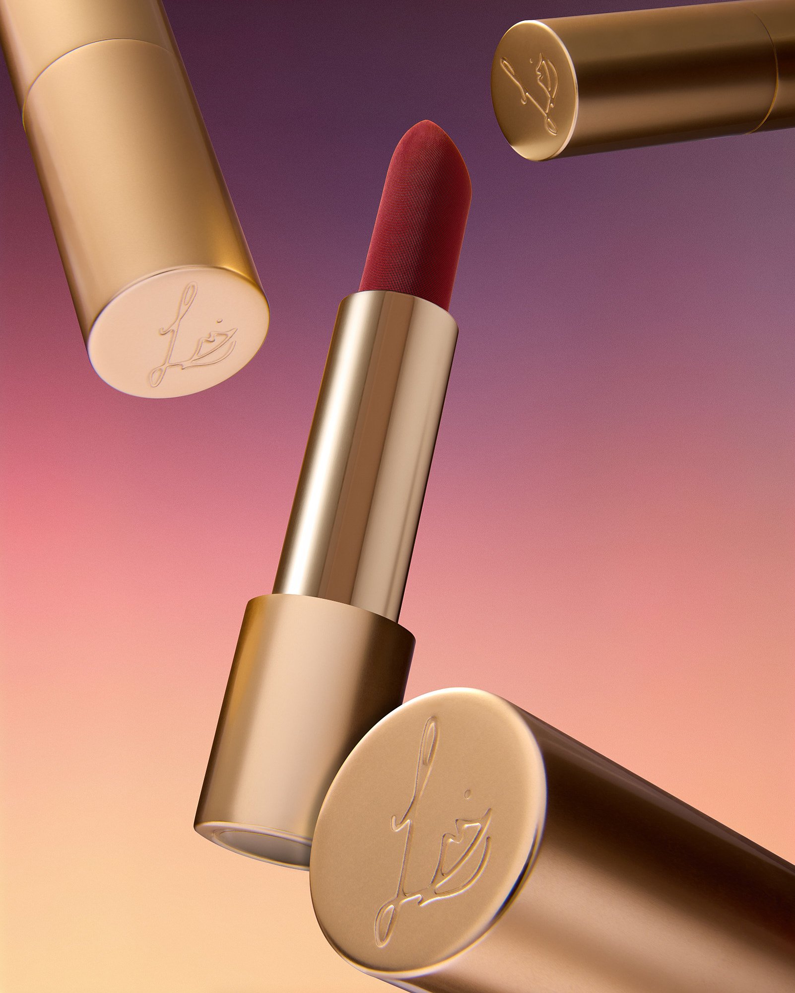 Close-up of Lipsense  Lisa Eldridge lipstick tubes with a pink and purple background.