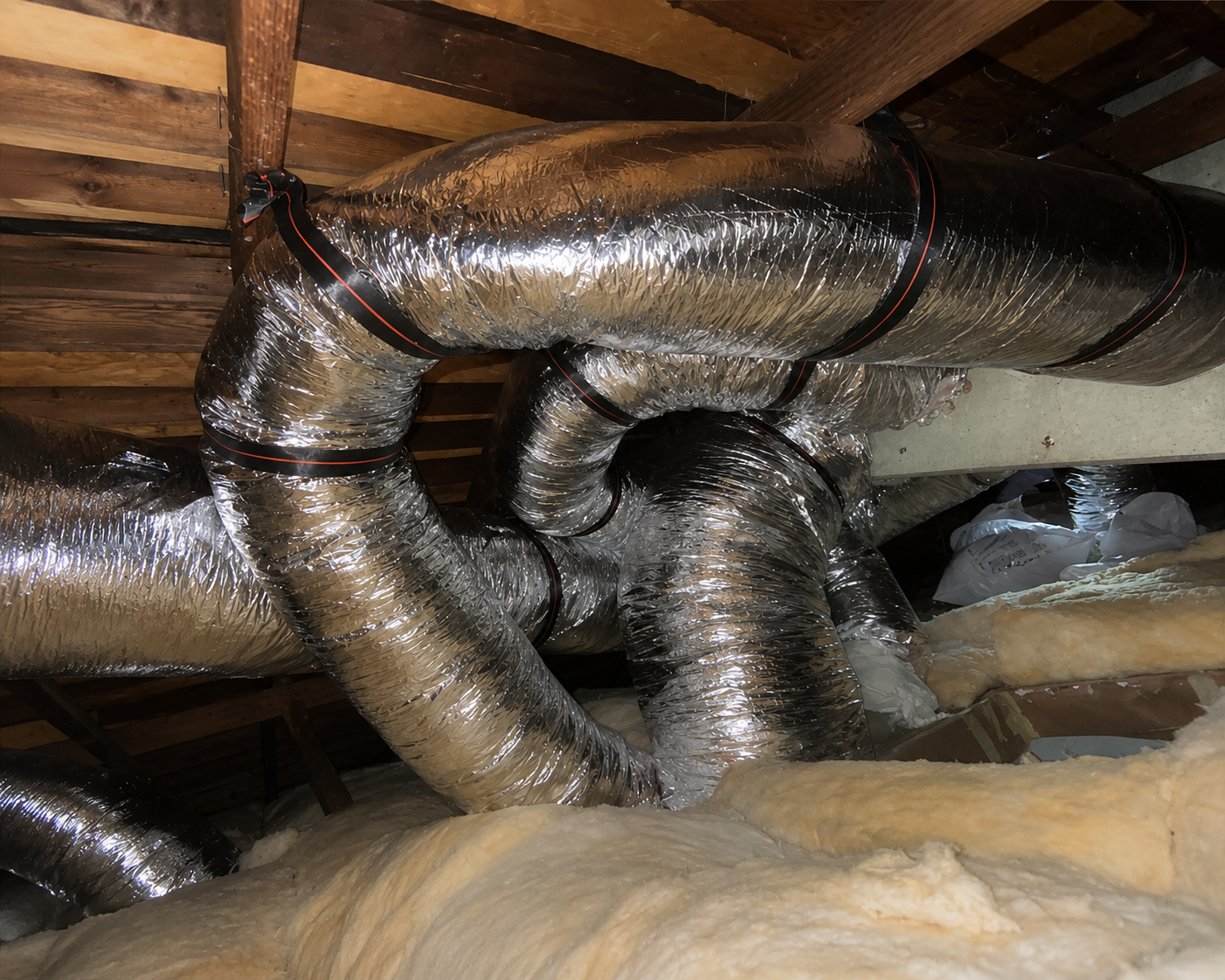New insulated air duct replacement professionally installed and sealed in a residential attic.