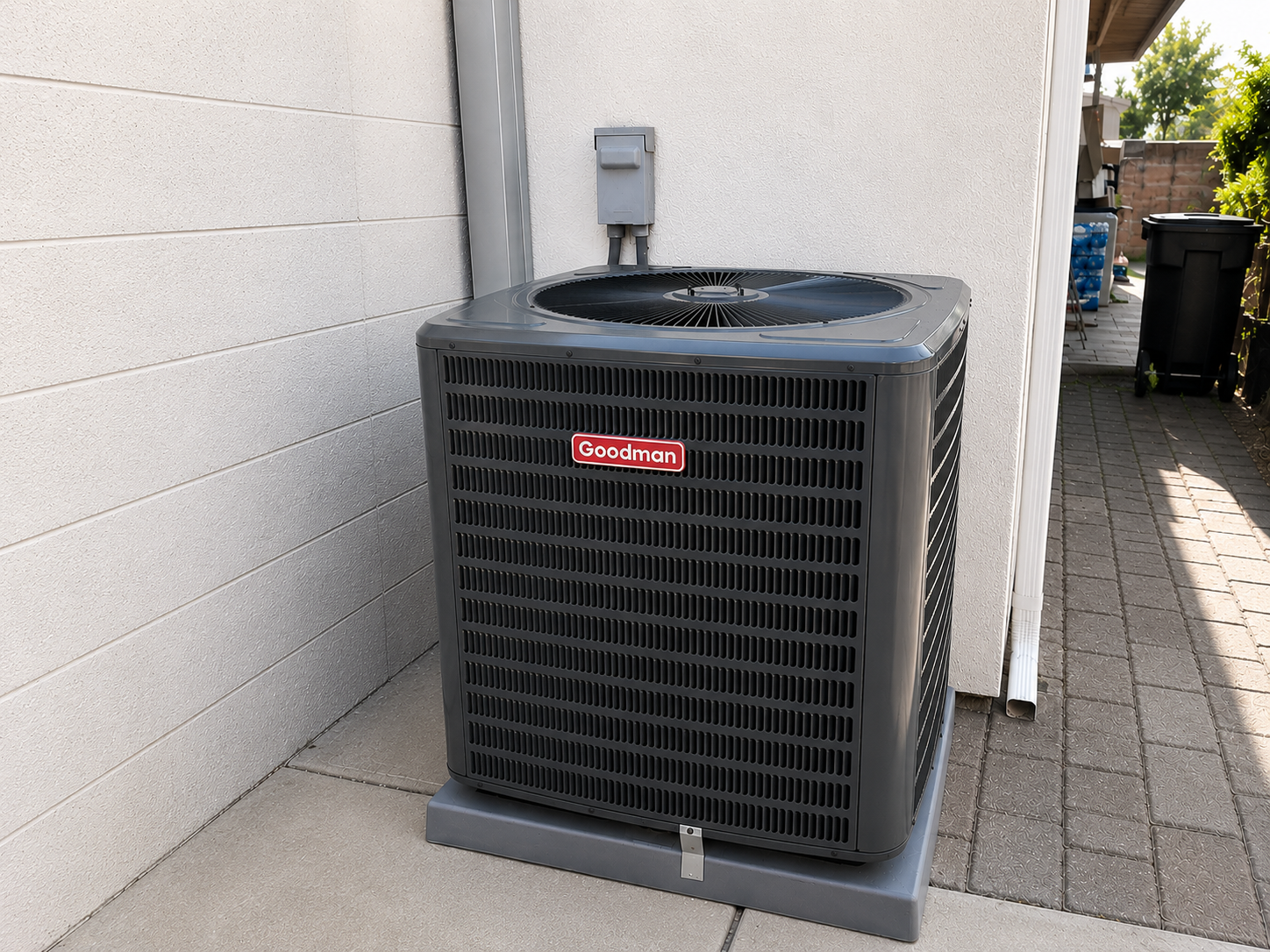 New residential Goodman air conditioning condenser professionally installed outside a home.