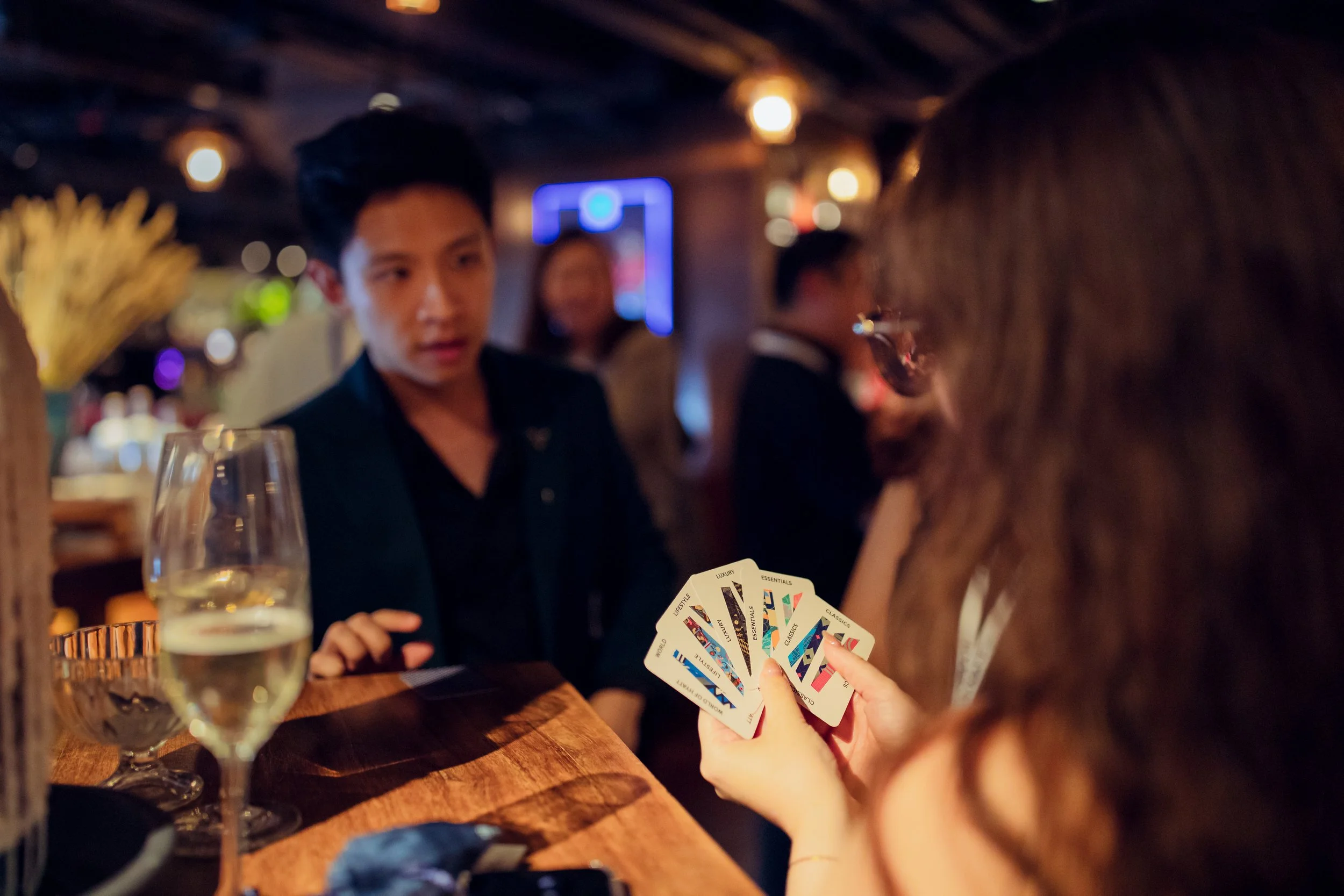 Jerryl Tan, asking his audience to pick cards for his magic trick at Grand Hyatt's corporate magic event.
