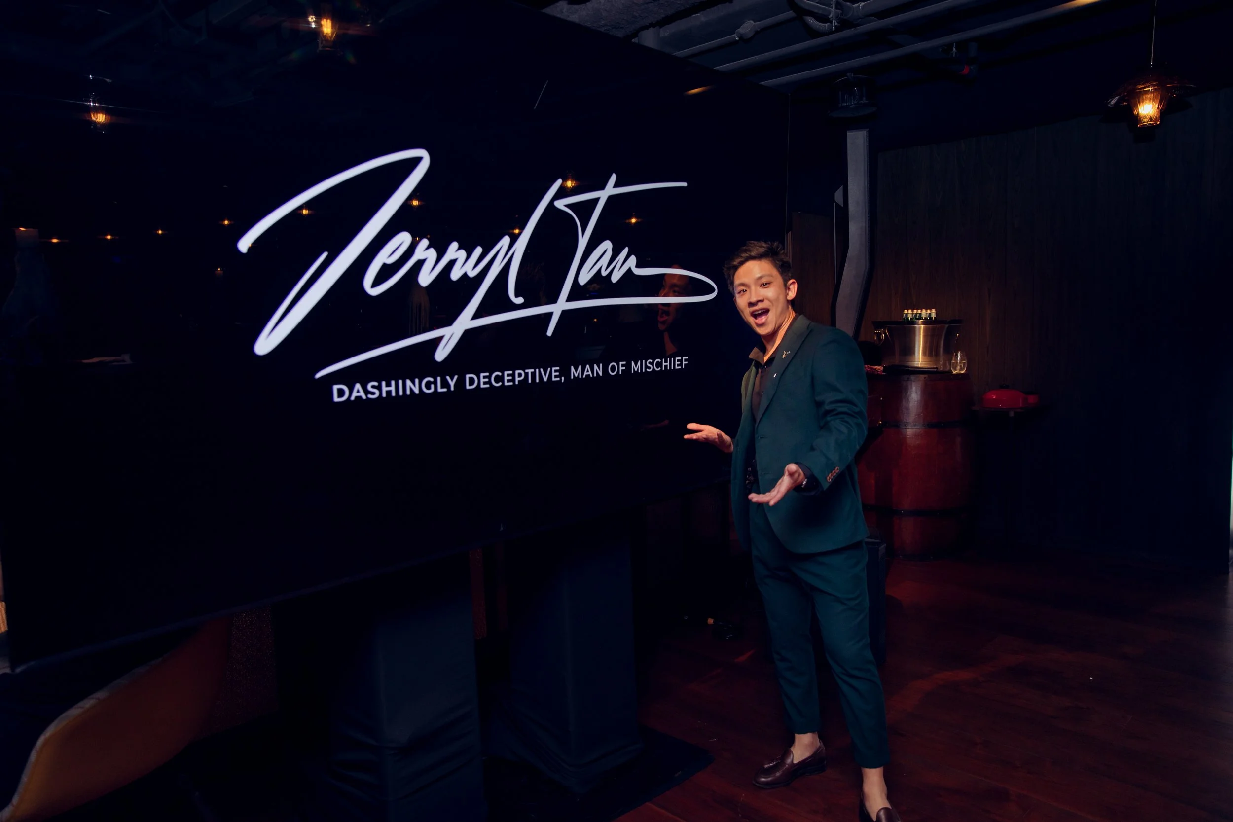 Magician Jerryl Tan at Grand Hyatt private event, he is performing a customised show and the photo shows Jerryl against his performance backdrop with his name.