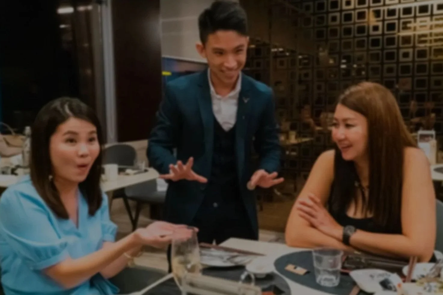 Jerryl Tan, Singapore magician, illusionist and pickpocket, Omakase close up magic for two female guest at a corporate event.