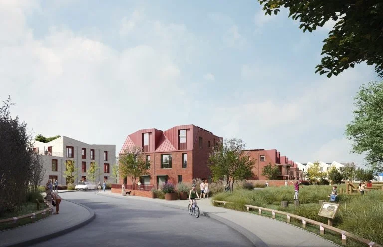 A modern residential neighborhood with colorful multi-story houses, trees, and a walking path with people and a cyclist under a partly cloudy sky.