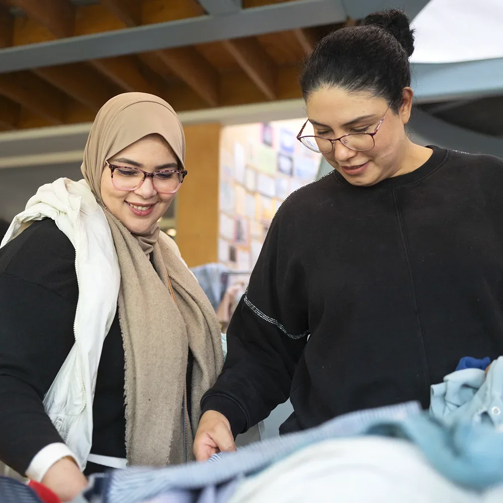 Two women looking through clothes