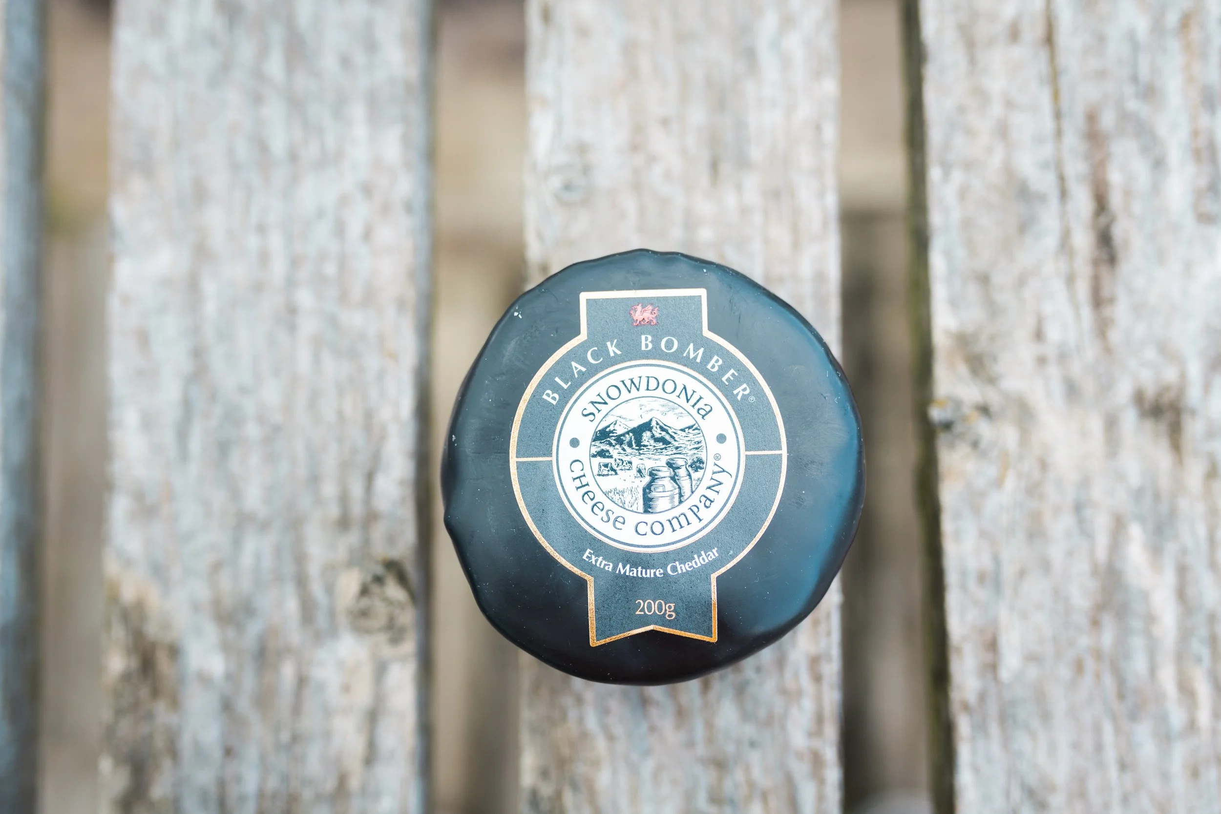 snowdonia cheese on a plank of wood