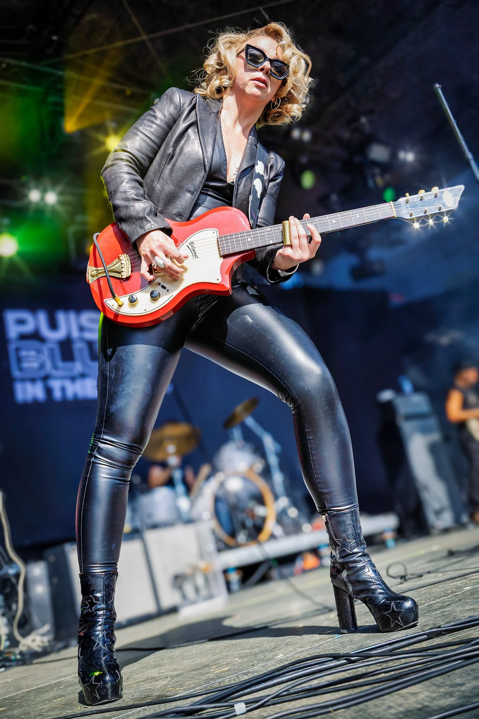 Samantha Fish playing a red electric guitar on stage at Puistoblues Festival in Järvenpää, Finland, 2026