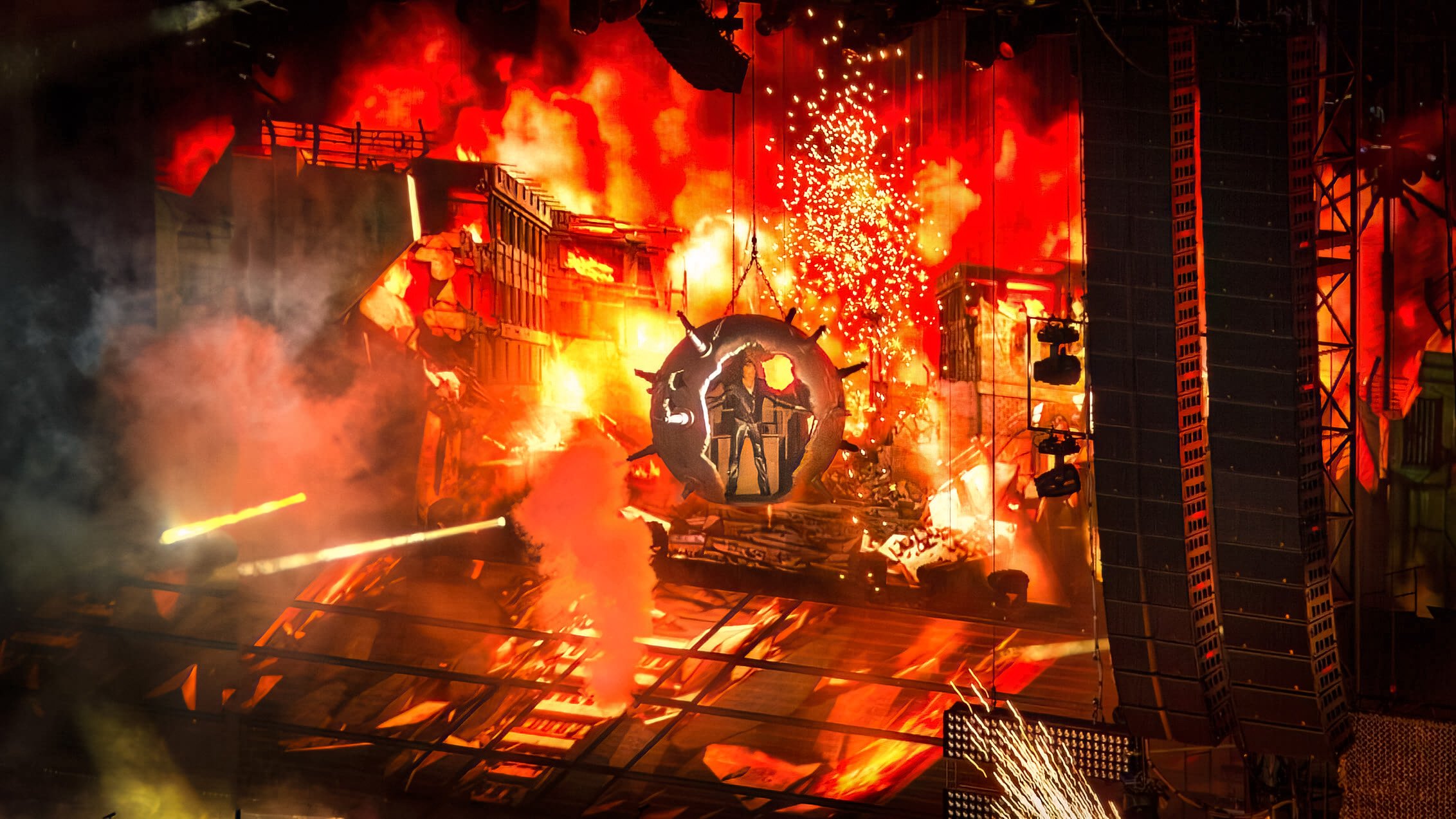 Johnny Hallyday makes a spectacular entrance inside a giant mine, surrounded by explosions and dramatic jets of spray. Stade de France, Paris, 2012.