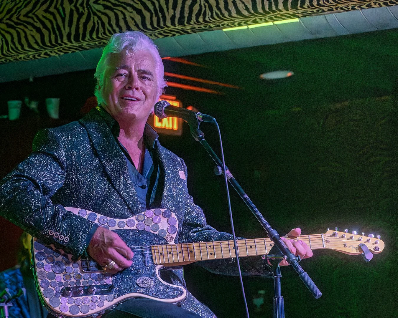 Texas honky-tonk star Dale Watson performing live at Hernando’s Hideaway in Memphis, Tennessee, in 2025, playing his distinctive coin-covered guitar.
