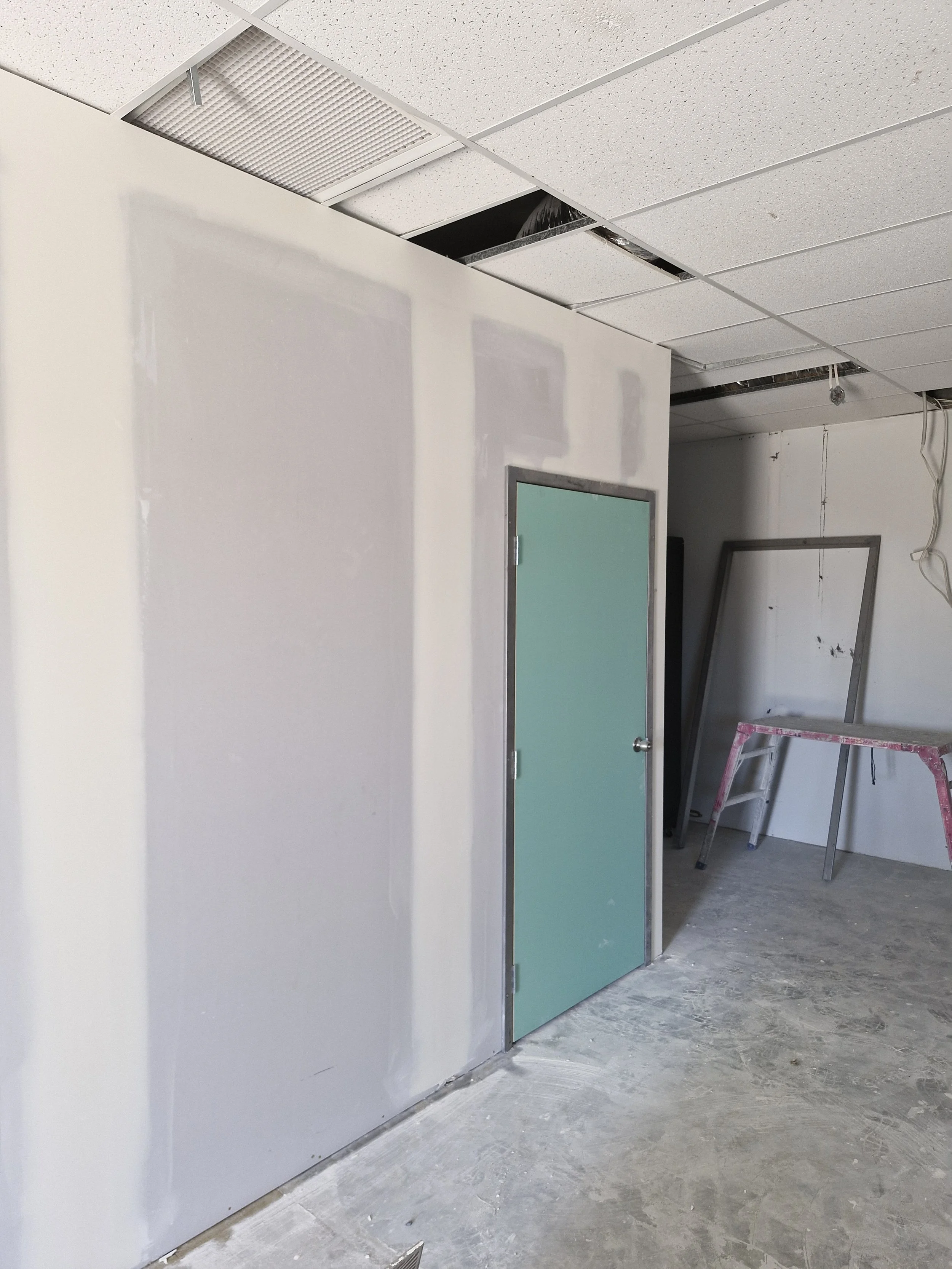 Construction site with sanded plaster ready for paint, drywall, ceiling tiles, complete walls