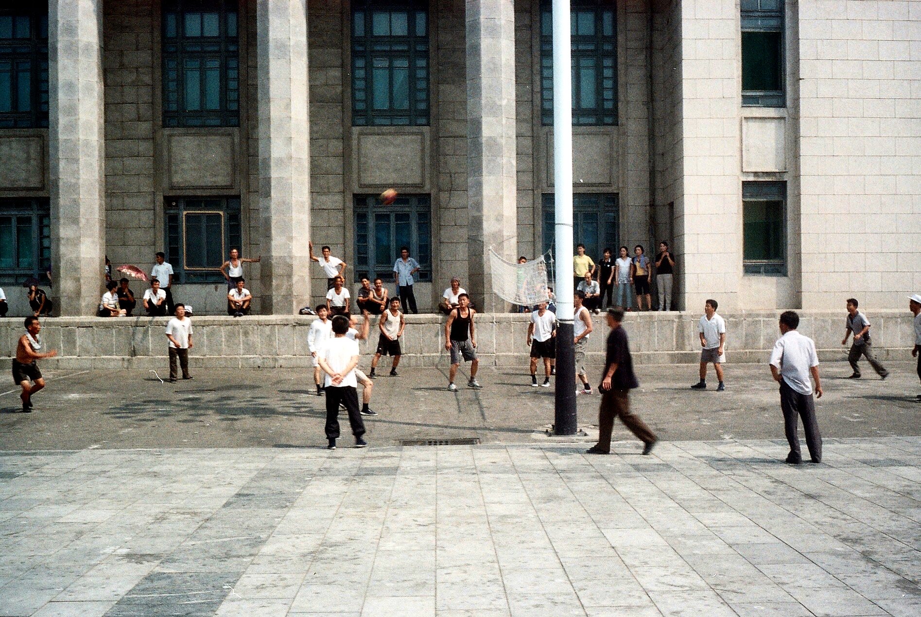 North Koreans play volleyball in Pyongyang's Kim il-Sung Square. The World Weekly, Aug 2015.