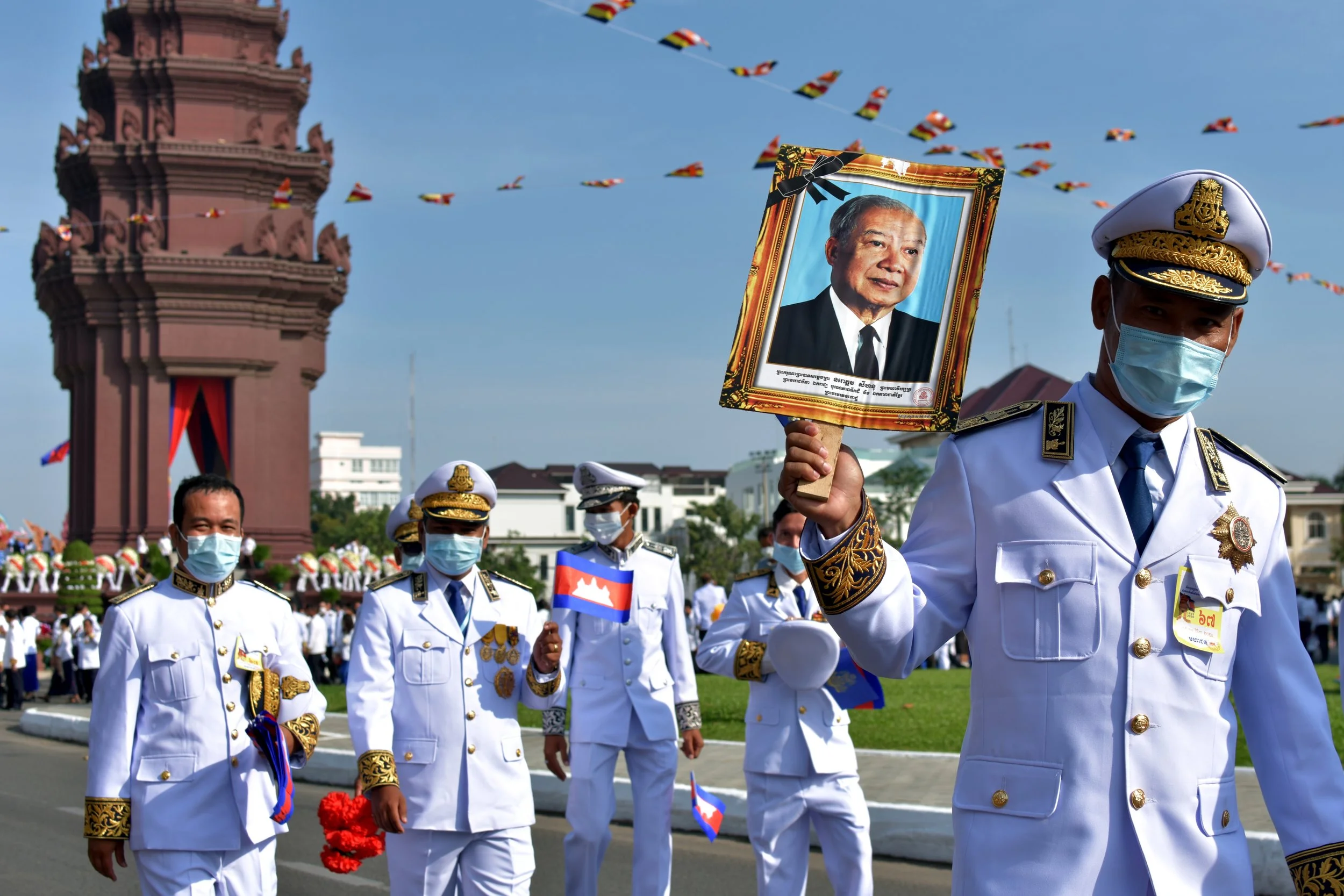 Cambodian military personnel, holding a photo of King Norodom Sihanouk, mark Independence Day in Phnom Penh. The Phnom Penh Post, Nov 2020. 