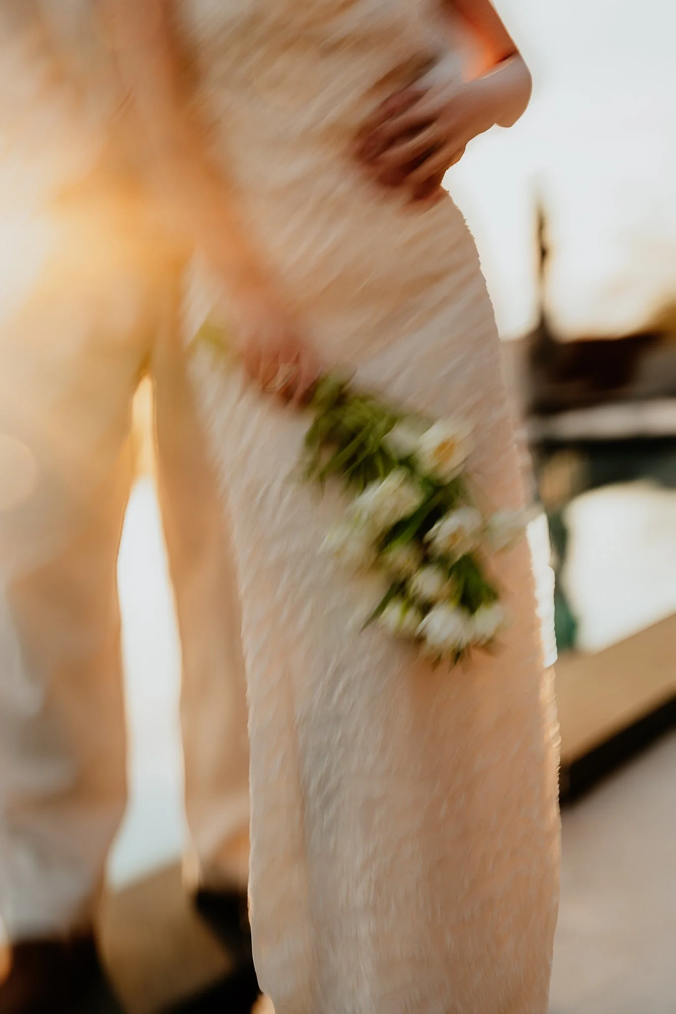 Close-up of a person holding a bouquet of white flowers.