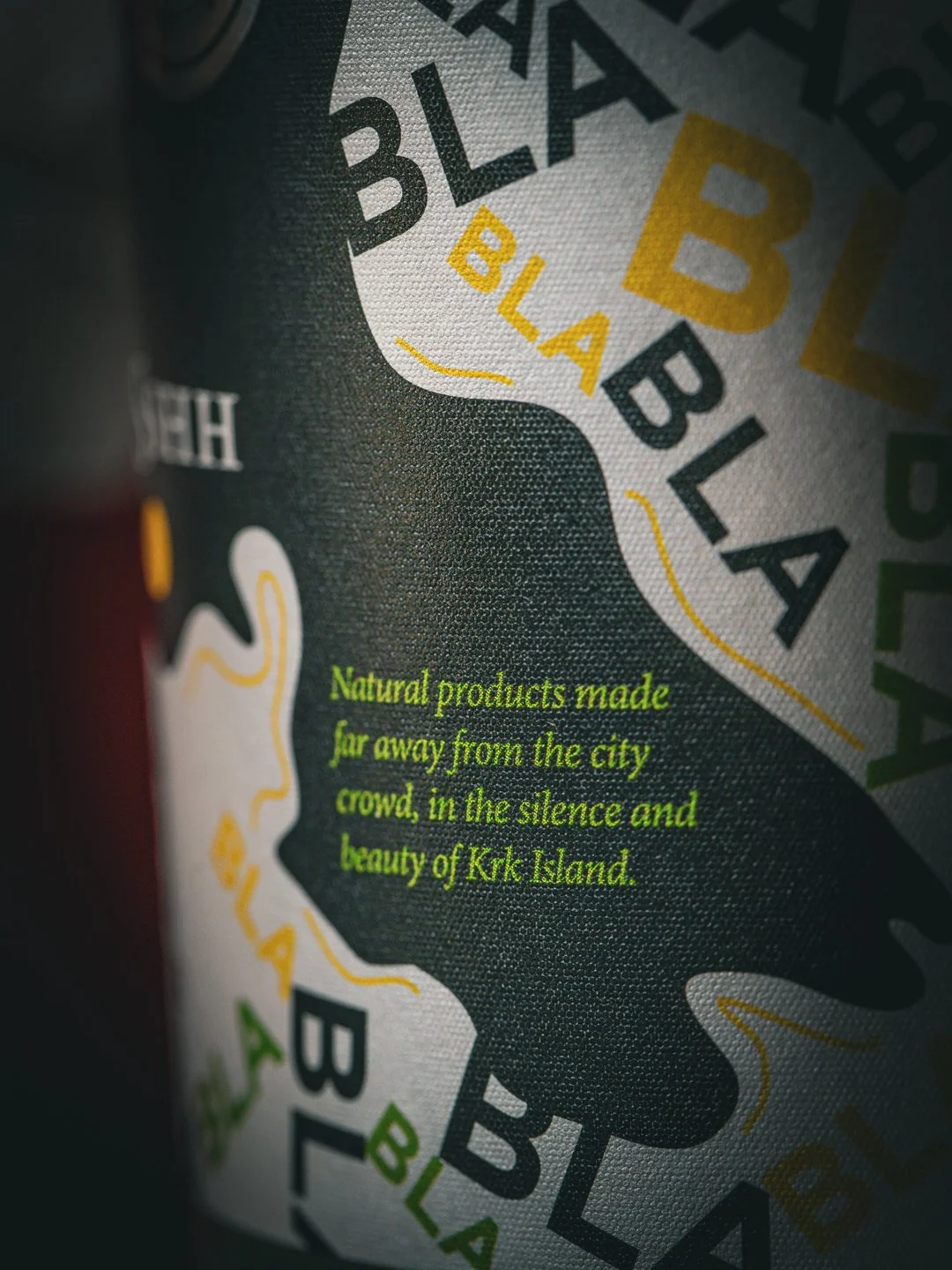 Close-up of Kirk Island product label with green text: "Natural products made far away from the city crowd, in the silence and beauty of Kirk Island."