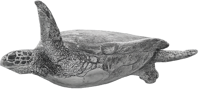 A detailed sculpture of a sea turtle in a horizontal position, mostly gray in color.