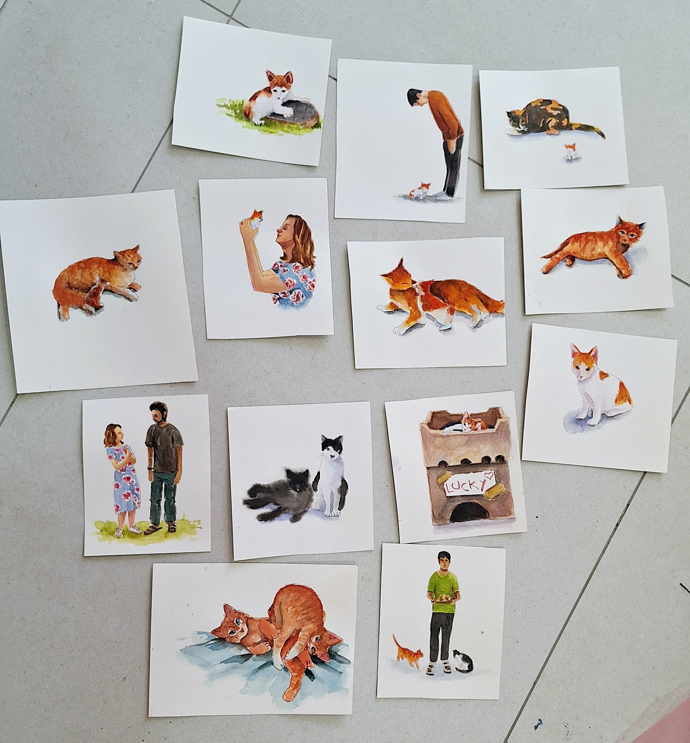 A collection of watercolor-style illustrations on paper depicting people and animals, including a woman with cats, a man with a cat, a woman and a woman, and various cats in different poses.