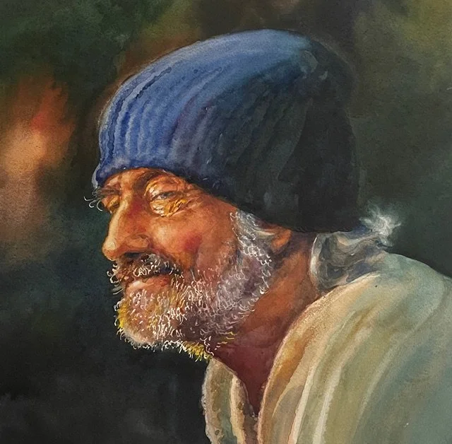 A realistic portrait of an elderly man with a beard, smiling gently, wearing a blue beanie, with a dark background.