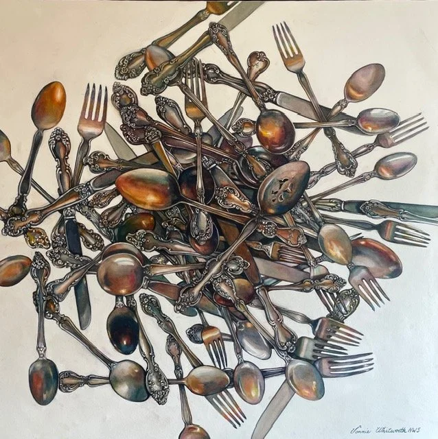 A pile of mixed vintage silverware including forks and spoons scattered on a white surface.