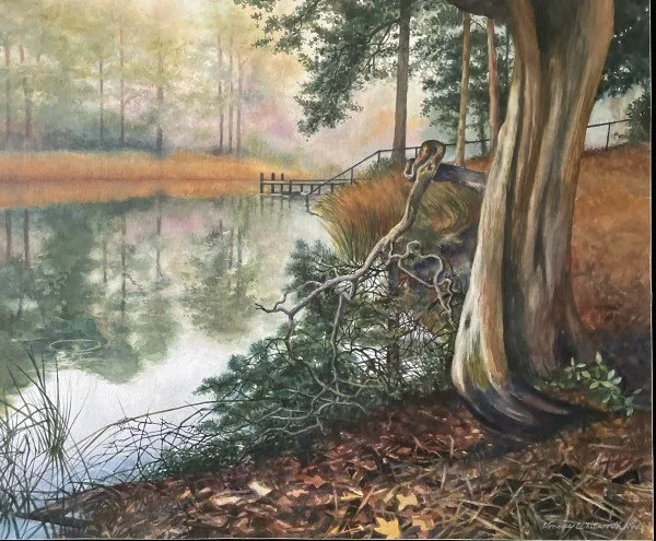 A serene autumn scene with a calm lake reflecting trees and a cloudy sky, a fallen tree branch near the water's edge, and a large tree trunk in the foreground.