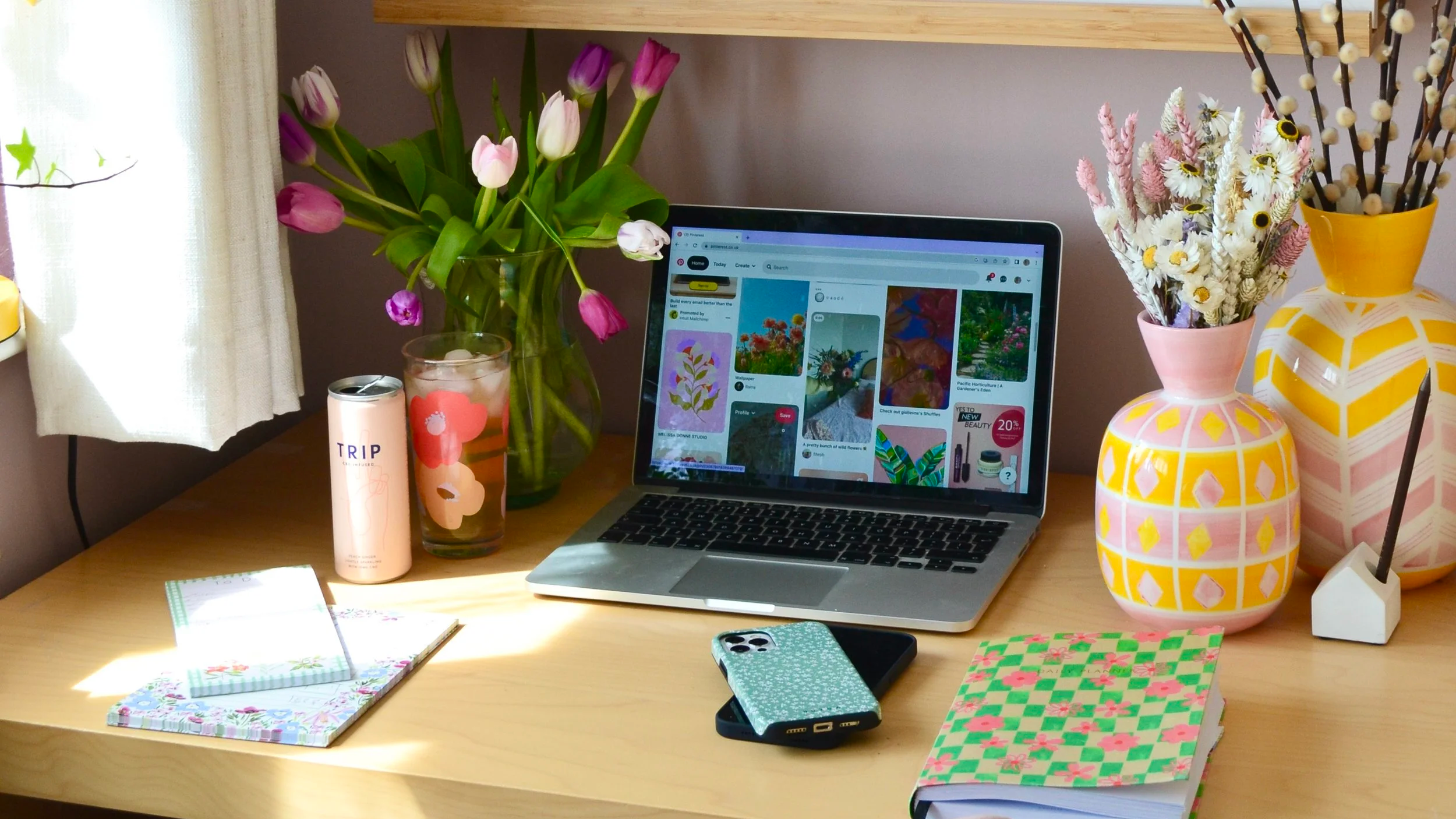 Home office desk with laptop, social media equipment and planning books