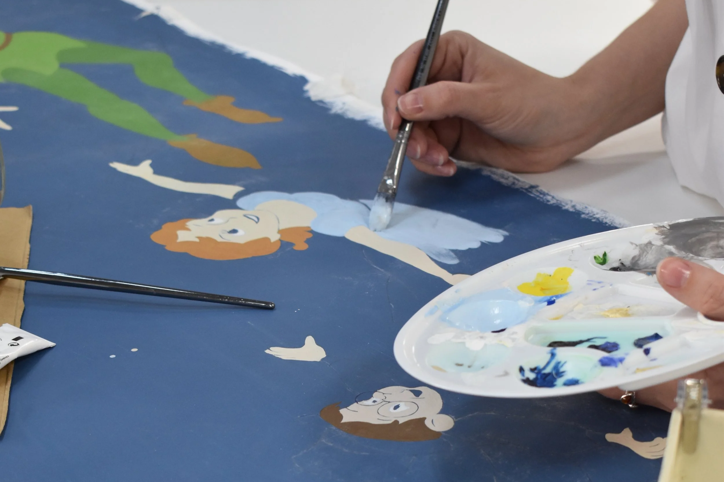 Social media content of artist painting a Disney Home wallpaper