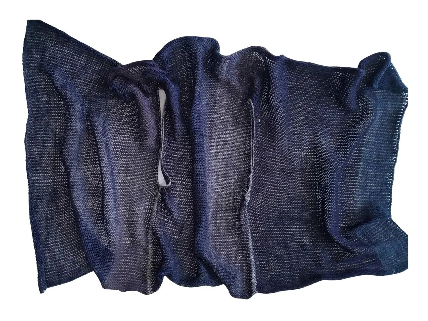 A knitted indigo-coloured rectangle that can be worn as a gilet, scarf or wrap.