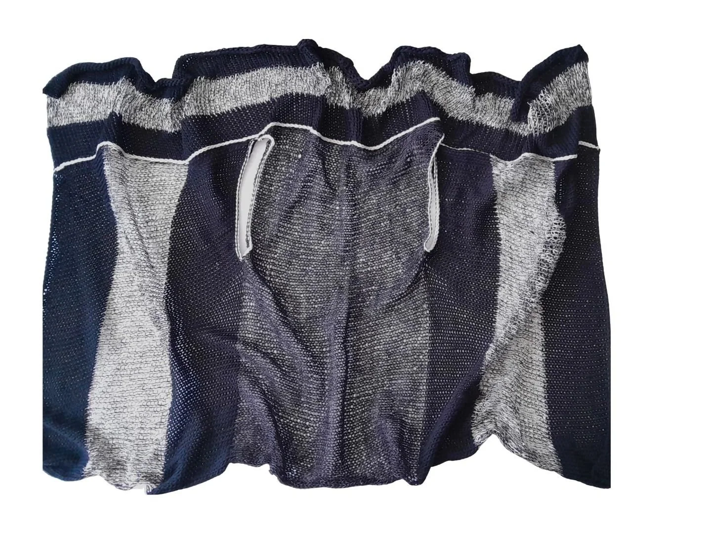A knitted rectangle in various textures and shades of blue. It can be be worn as a gilet, scarf or wrap.