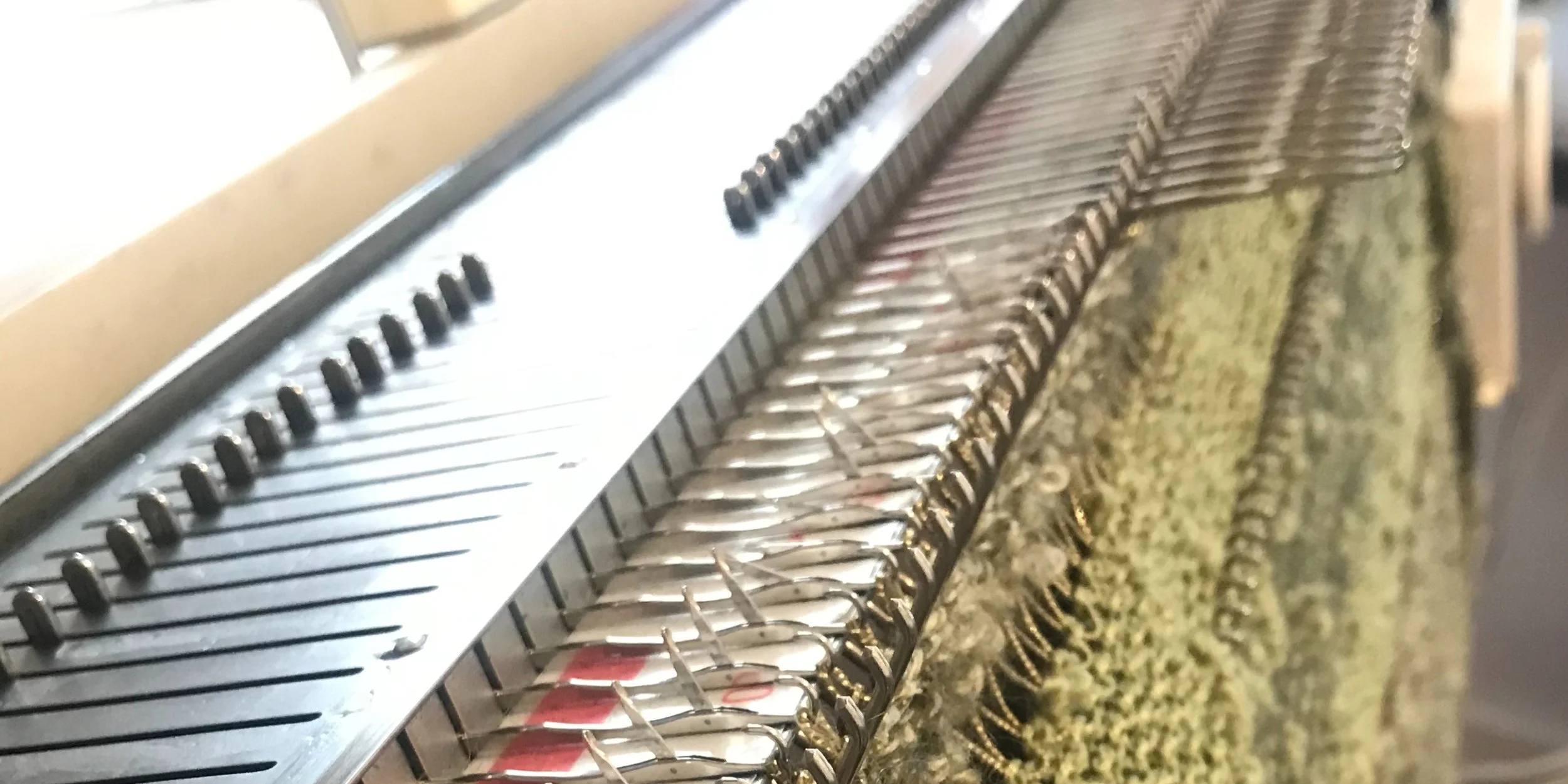 Close-up of the bed of a vintage domestic knitting machine.