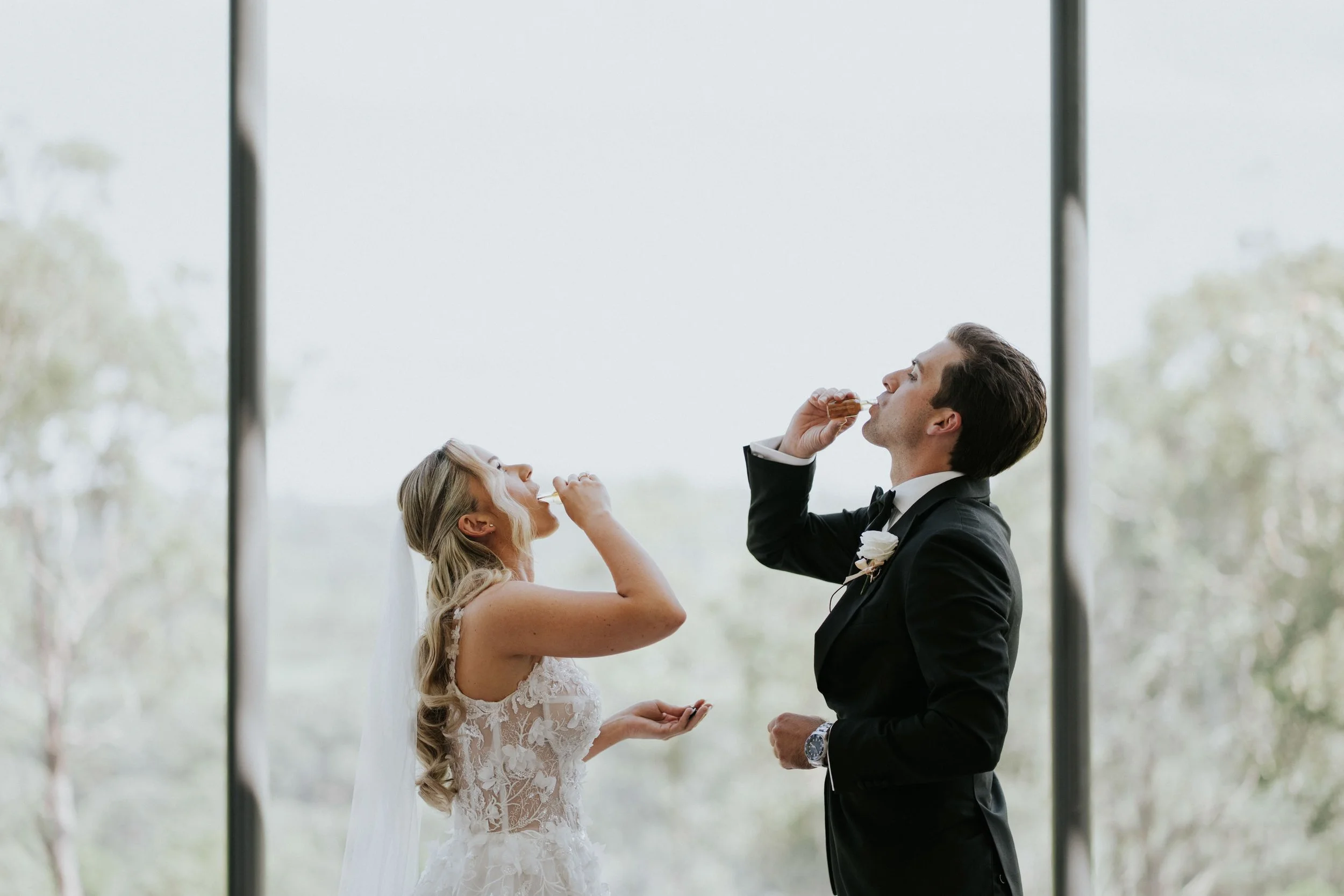 A bride and groom sharing a tender moment during their wedding, with the groom feeding the bride a piece of cake at their ceremony.