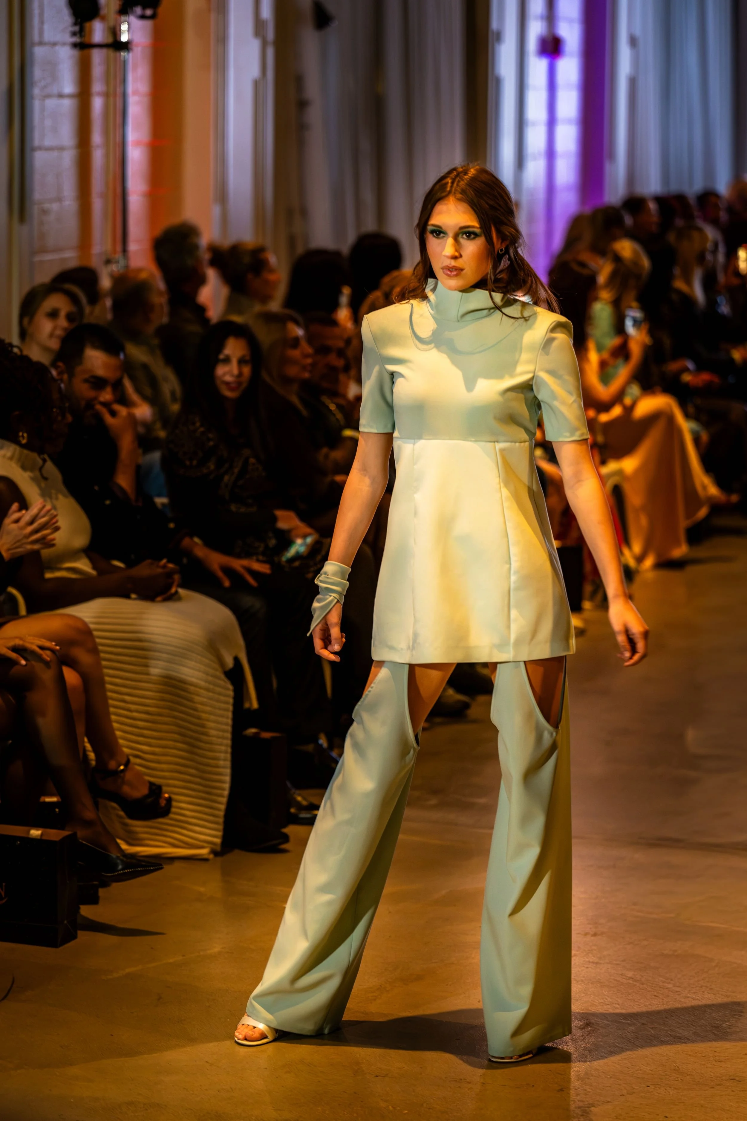 Model wearing a mint-green tunic and matching wide-leg trousers at Charlotte Fashion Week