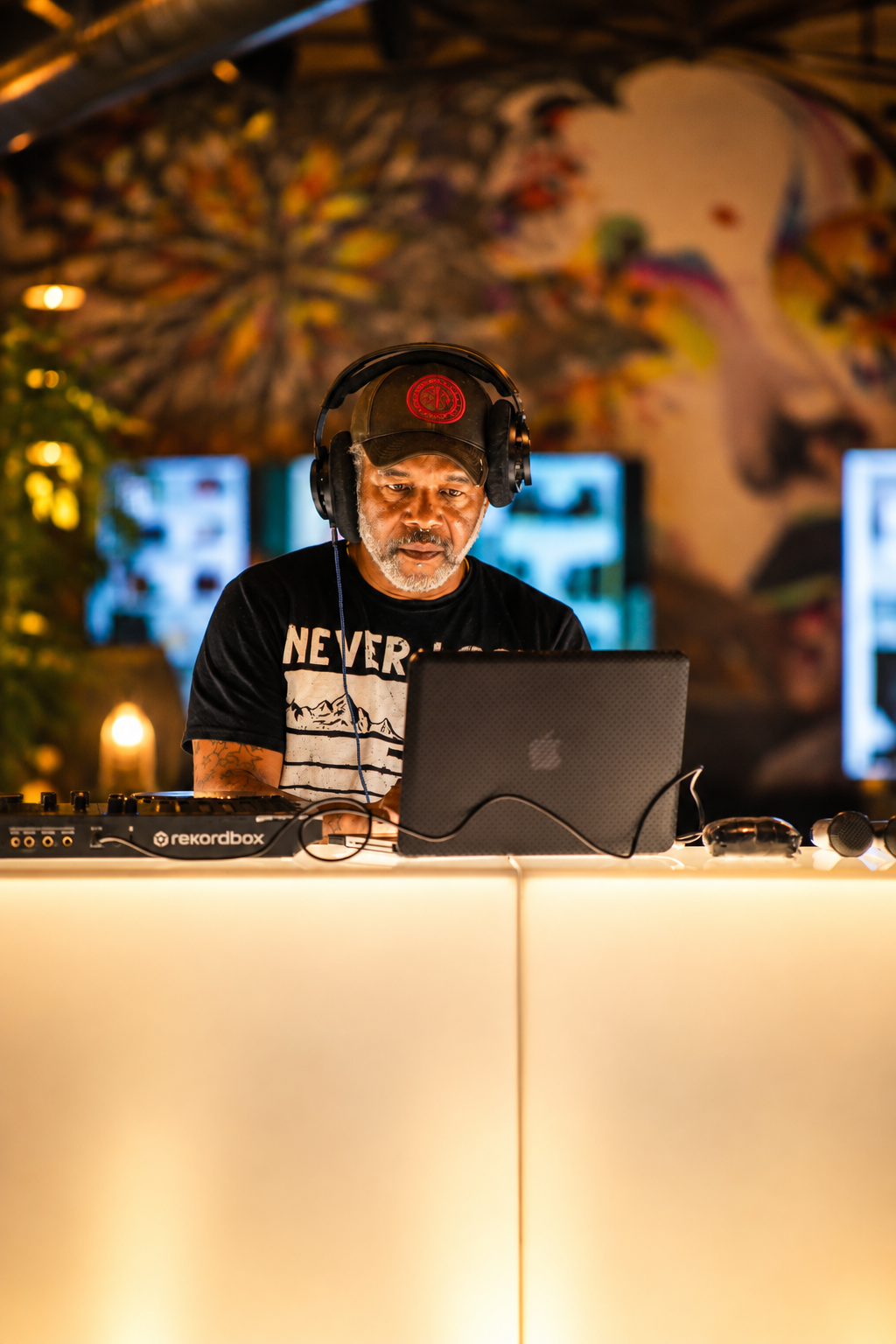 DJ performing at a Charlotte event behind a mixing console
