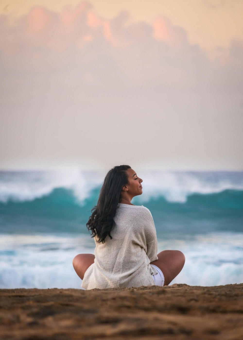 Mindfulness and nervous system regulation practice by the ocean in Hawaii.