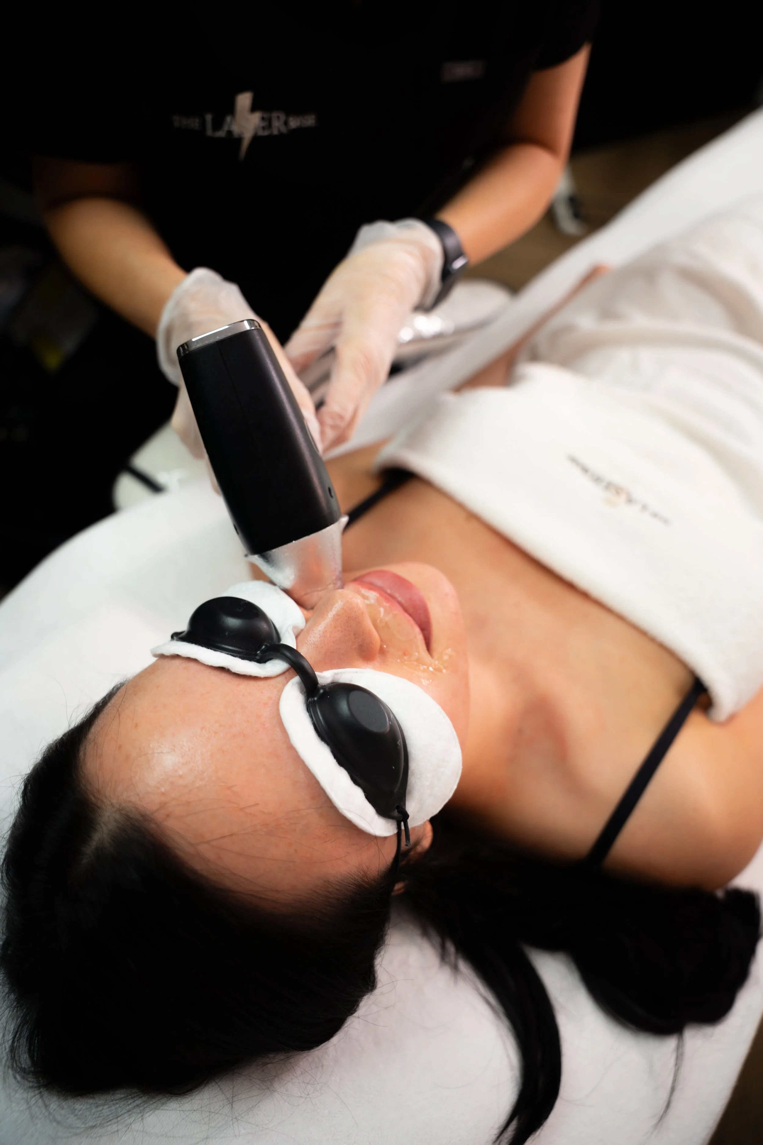 Client in protective goggles during a professional laser treatment — safe practice taught on our VTCT courses.
