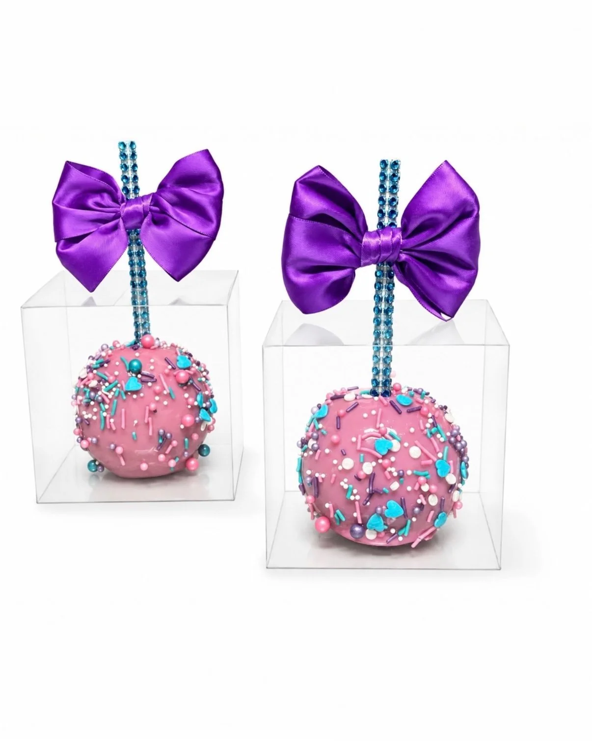 Pink candy apples with purple bows by The Dipped Factory