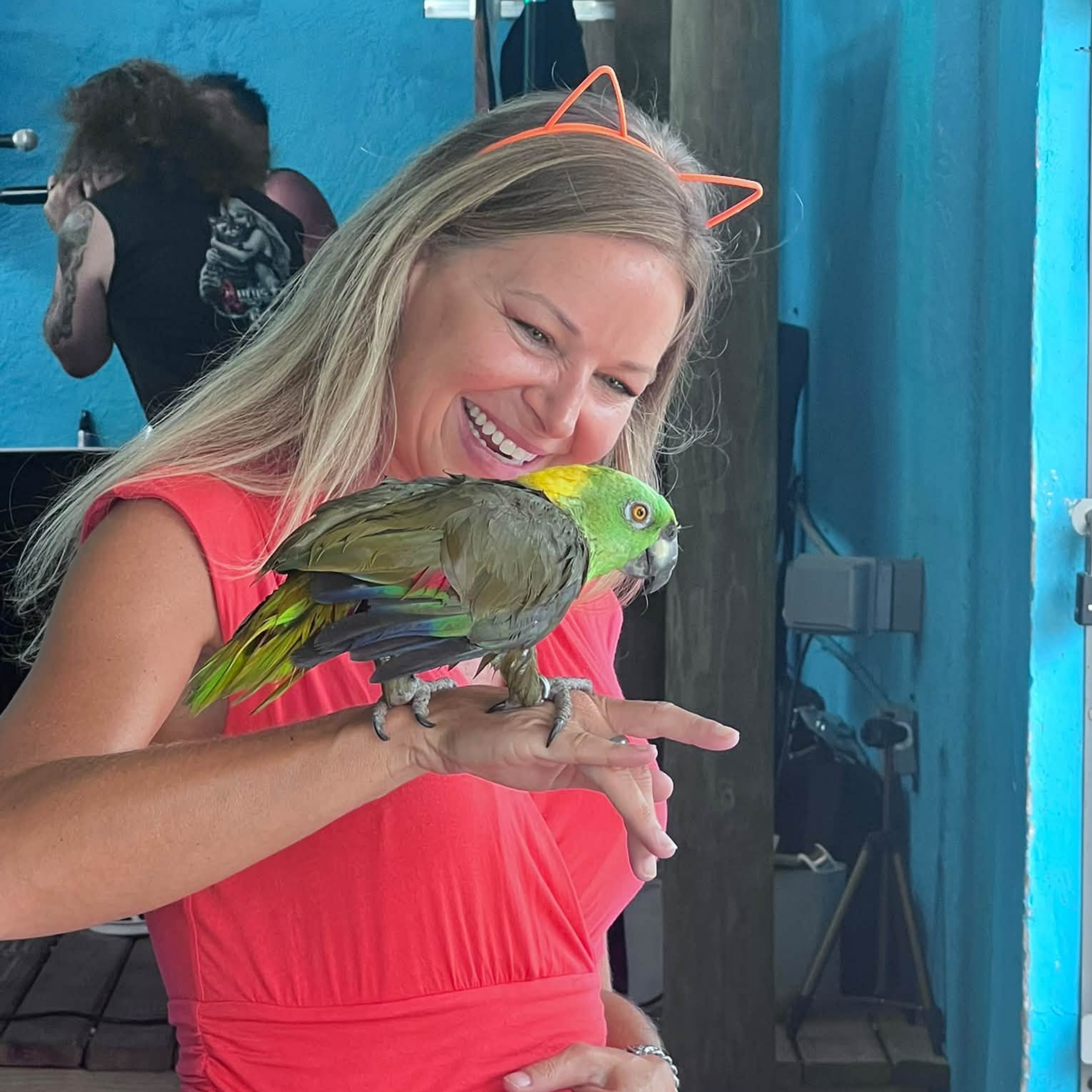 Shannon having fun with someone's parrot at the Lucy's Fur Baby show