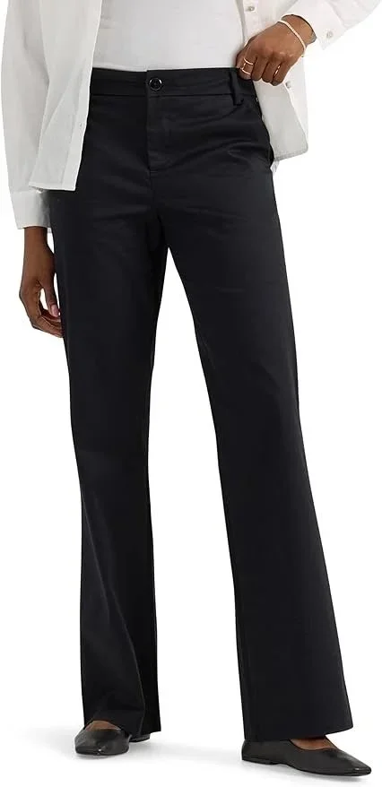Person wearing black wide-leg pants, a white shirt, a white jacket, black shoes, and a bracelet.
