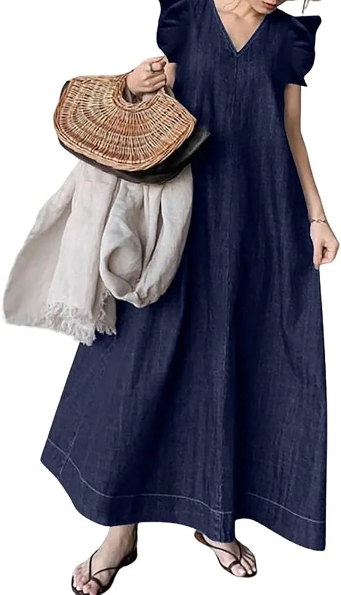 Person wearing a navy dress with puffed sleeves, holding a woven handbag, with beige wide-leg pants, and wearing black strappy sandals.