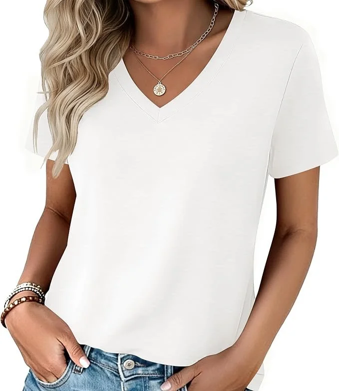 A woman wearing a plain white V-neck T-shirt, layered gold necklaces, and multiple bracelets on her left wrist, with her right hand in her jeans pocket.