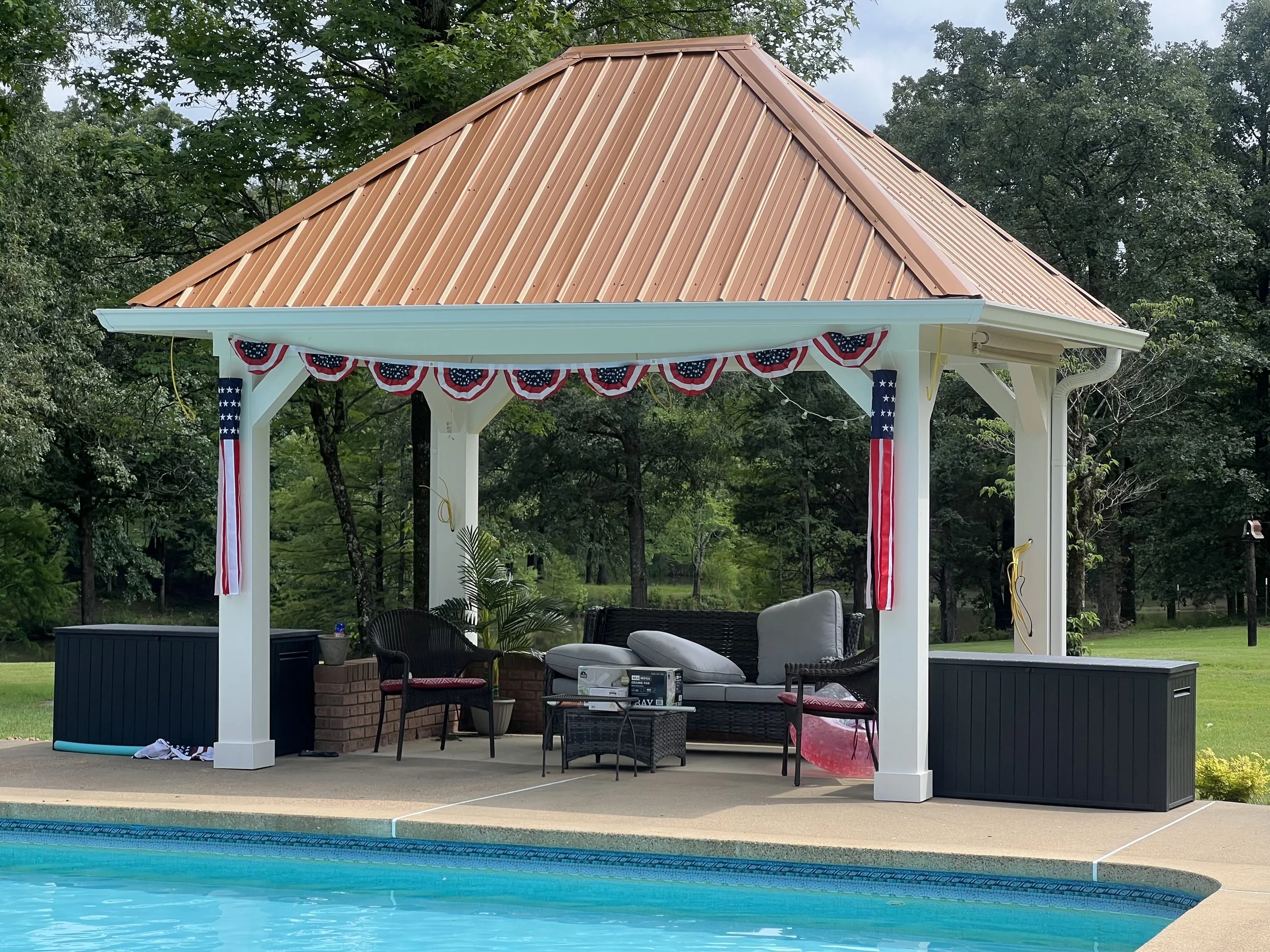 Seamless gutter installation completed on a beautiful home with a copper-colored metal roof in Hernando, MS.