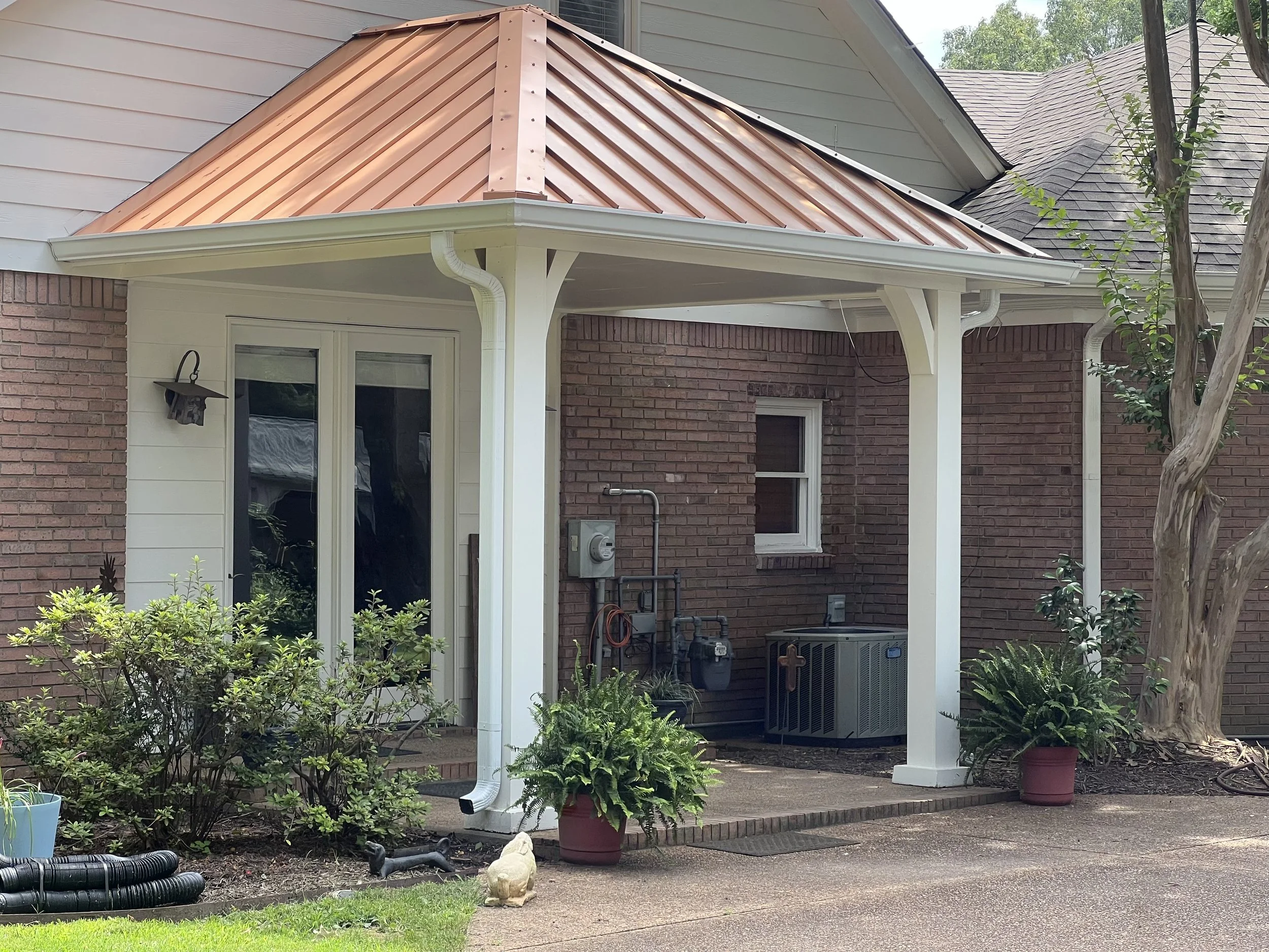 Custom seamless gutters installed to complement a copper metal roof in Hernando, MS.