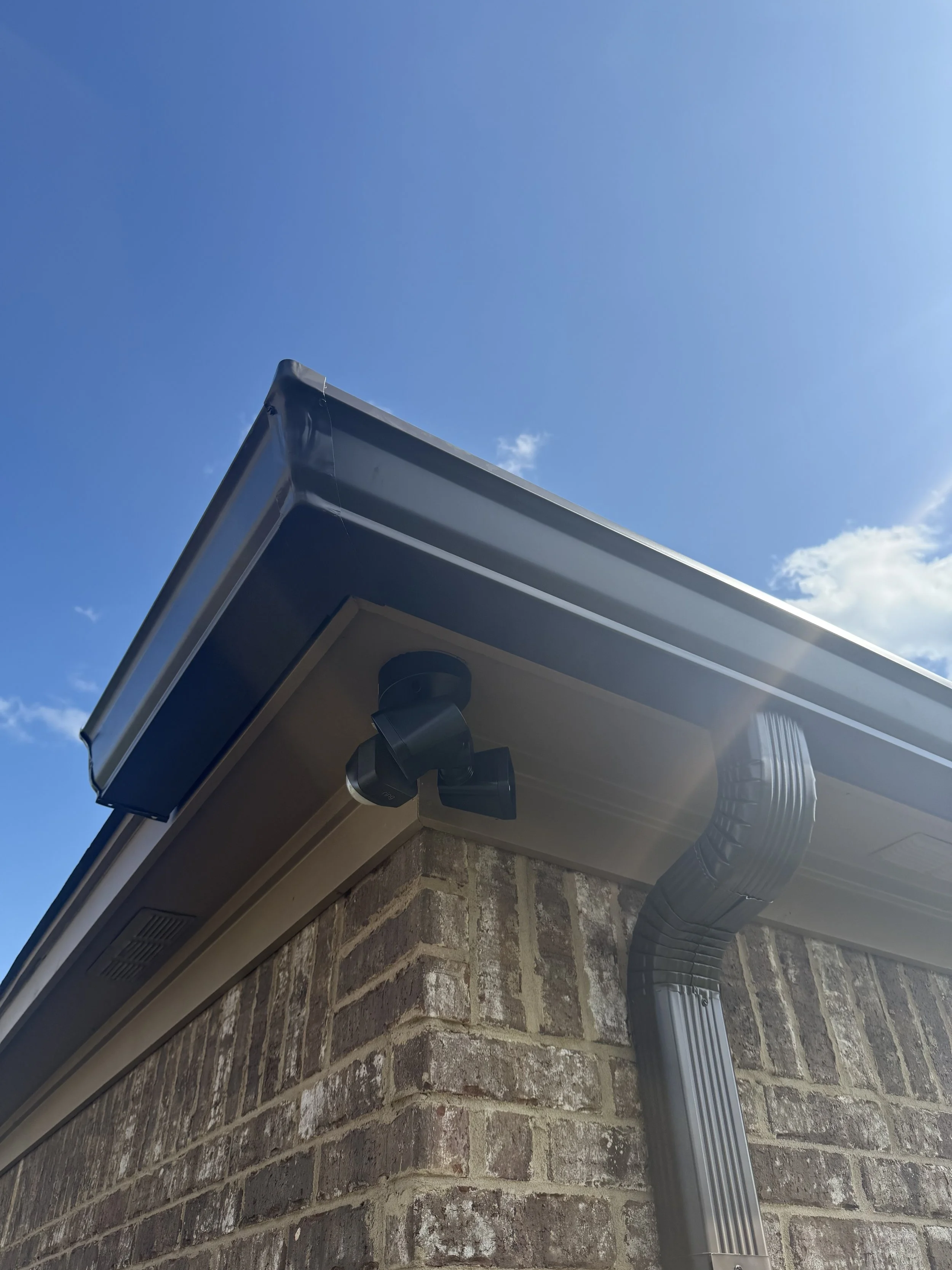 Detail of the finished gutter corner and downspout, custom fitted for efficient water drainage.