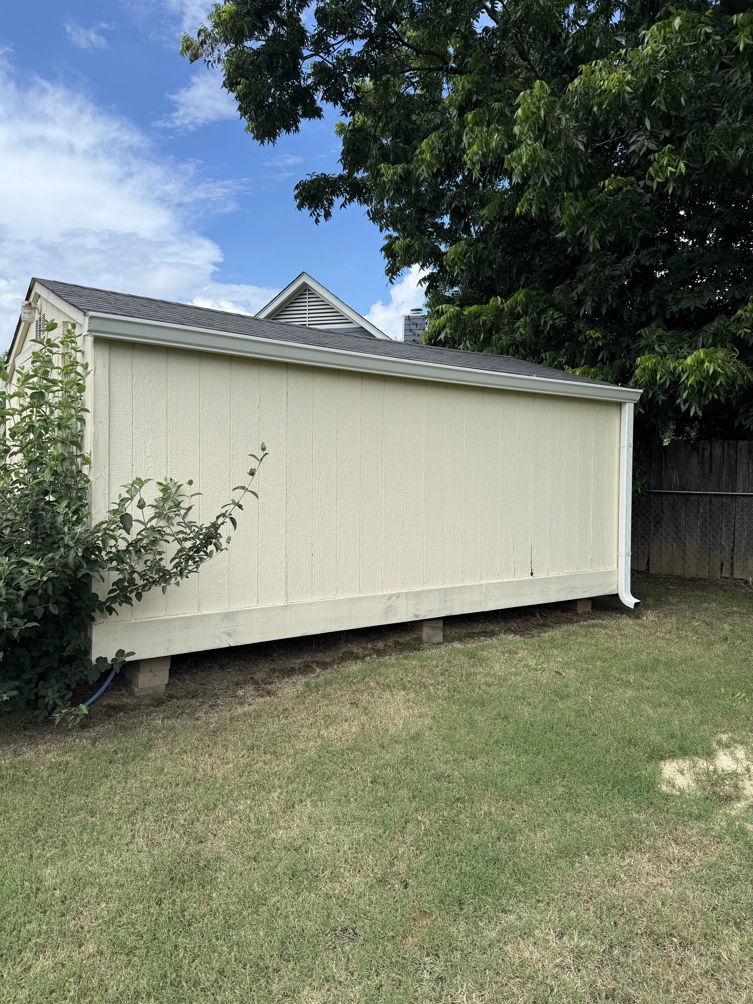 White seamless gutters installed on a storage shed in Olive Branch, MS, for improved water management and long-lasting protection.